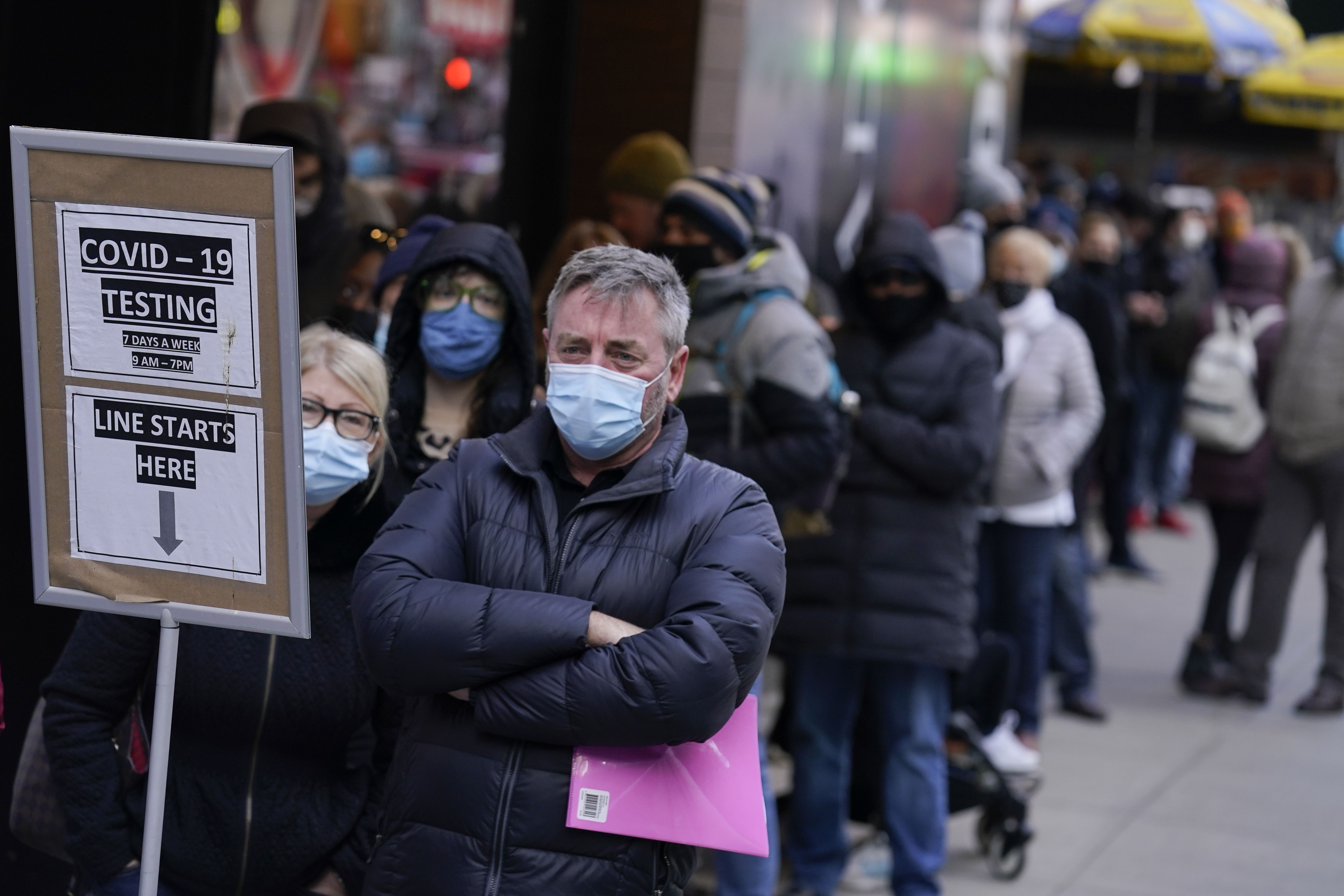 People wait in line at a COVID-19 testing site in Times Square, New York, Monday, Dec. 13, 2021. Scientists are warning that omicron’s lightning-fast spread across the globe practically ensures it won’t be the last worrisome coronavirus variant.