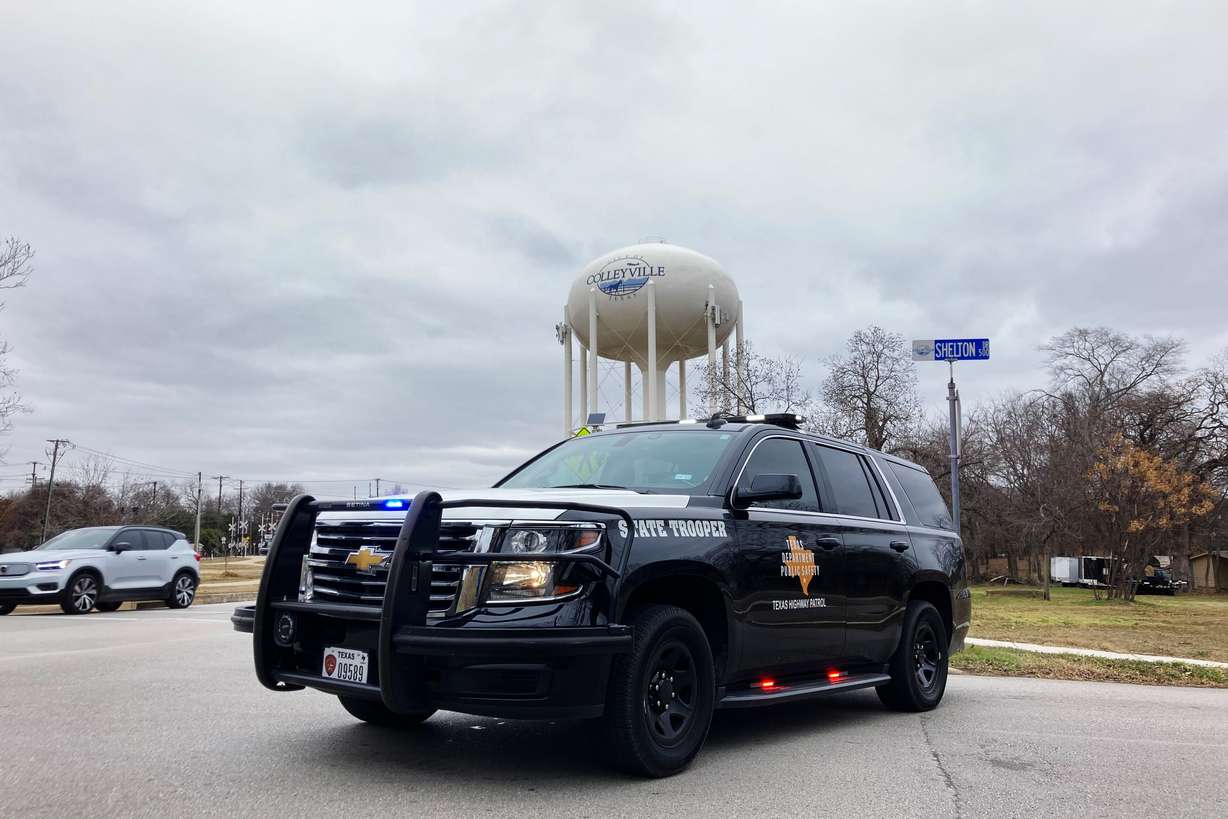 A Texas state trooper blocks traffic on a road leading to a Colleyville, Texas, synagogue where a man apparently took hostages, Saturday.