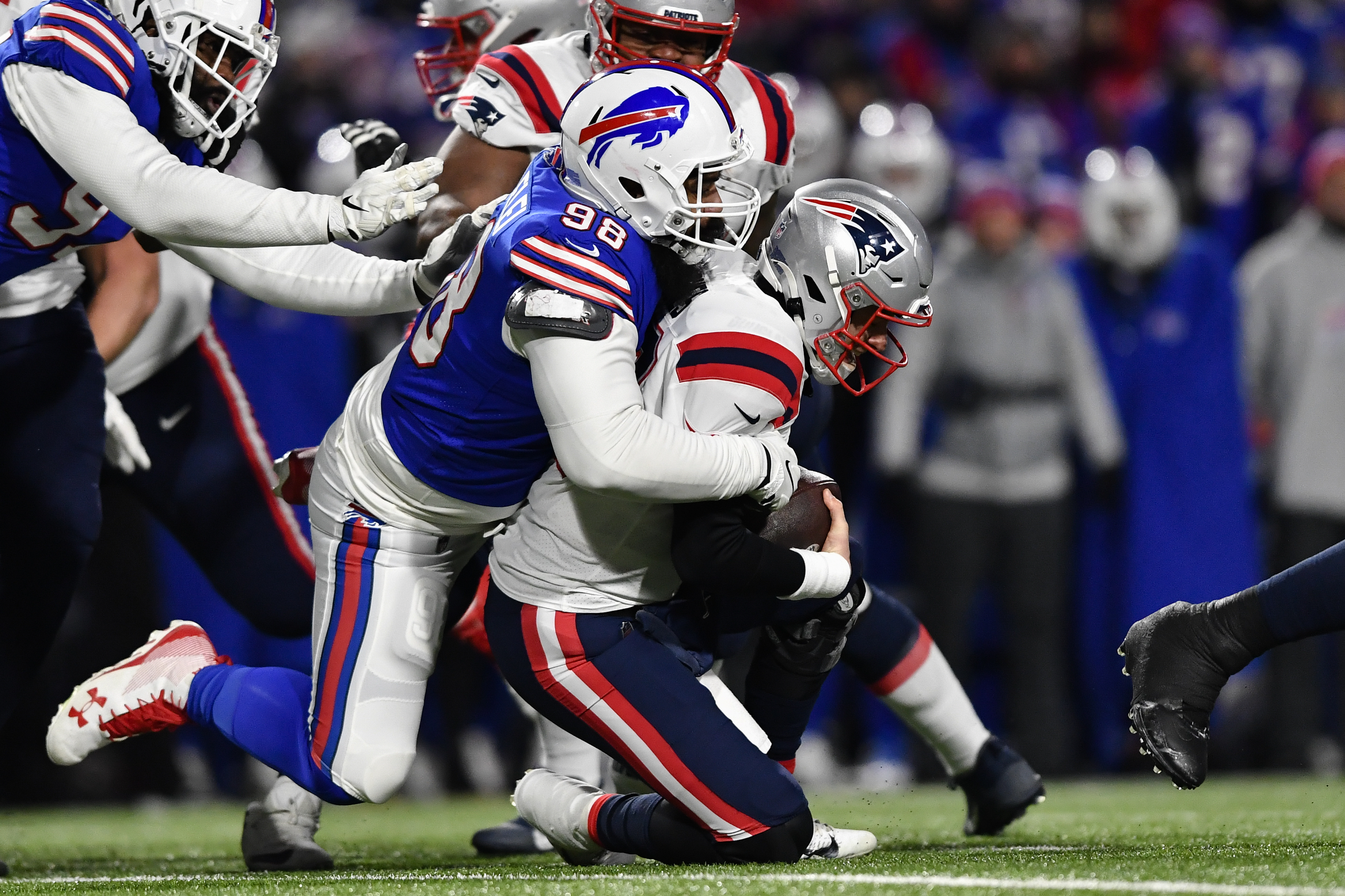 New England Patriots quarterback Mac Jones (10) is sacked by Buffalo Bills defensive tackle Star Lotulelei (98) during the first half of an NFL wild-card playoff football game, Saturday, Jan. 15, 2022, in Orchard Park, N.Y.