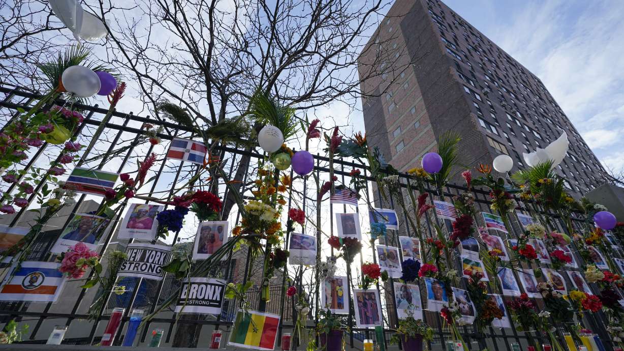 A memorial for the victims of an apartment building fire is displayed in front of the building in the Bronx borough of New York, Thursday. Many of the victims of New York City’s deadliest fire in years are still awaiting burial after funerals began with services for two children killed by last Sunday’s blaze in a Bronx apartment building.