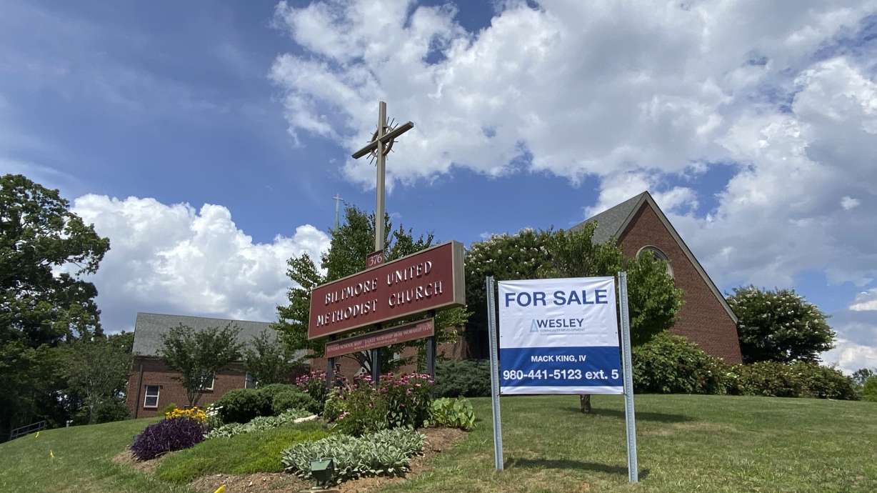 A "For Sale" sign in front of the Biltmore United Methodist Church in Asheville, N.C. in July 2021. Already financially strapped because of shrinking membership and a struggling preschool, the congregation was dealt a crushing blow by the coronavirus.