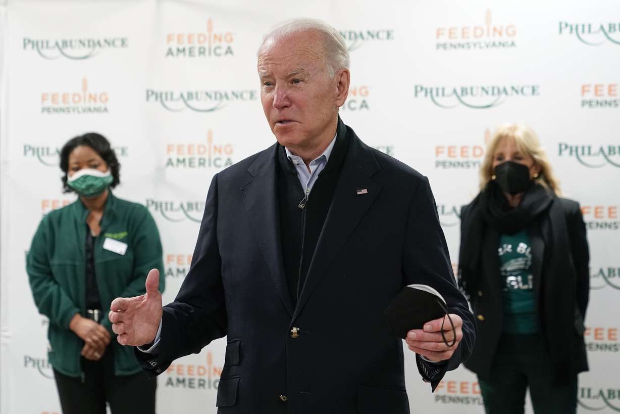 President Joe Biden speaks with members of the press about the Texas synagogue hostage incident before volunteering with first lady Jill Biden, back right, at hunger relief organization Philabundance, Sunday, in Philadelphia.
