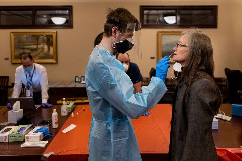 Utah Department of Health employee Brenner Miller,
left, swabs Sen. Ann Millner, R-Ogden, for a COVID-19 rapid test in
the Senate Rules Room at the Capitol in Salt Lake City on
Jan. 28, 2021.
