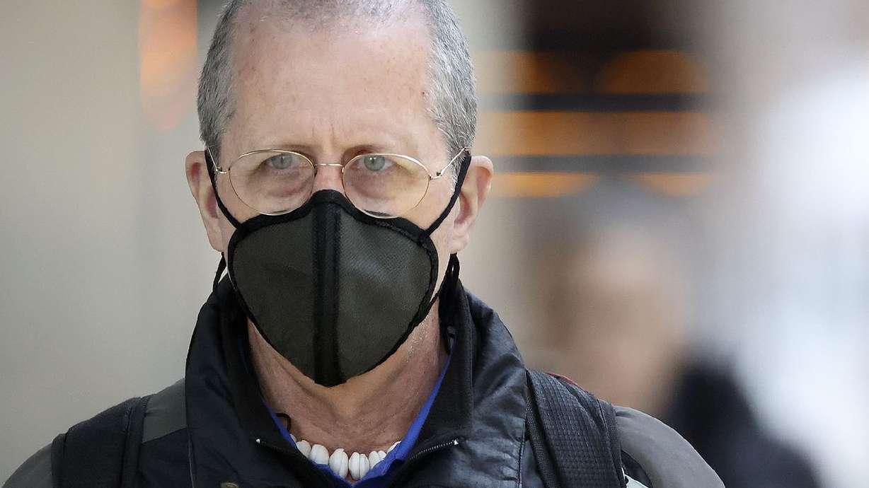 Patrick Milligan wears a mask while walking through downtown Salt Lake City on Jan. 7. A mask mandate in Salt Lake County went into effect on Jan. 8 in response to a surge in omicron COVID-19 cases.