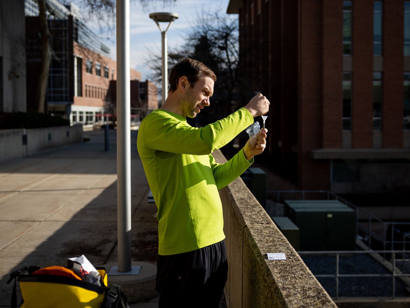 David Dorsey, an ICU doctor at the University of Utah
Hospital, takes a self-administered COVID-19 test that he got out
of a vending machine at the Eccles Health Sciences Library on the
University of Utah campus in Salt Lake City on Tuesday.