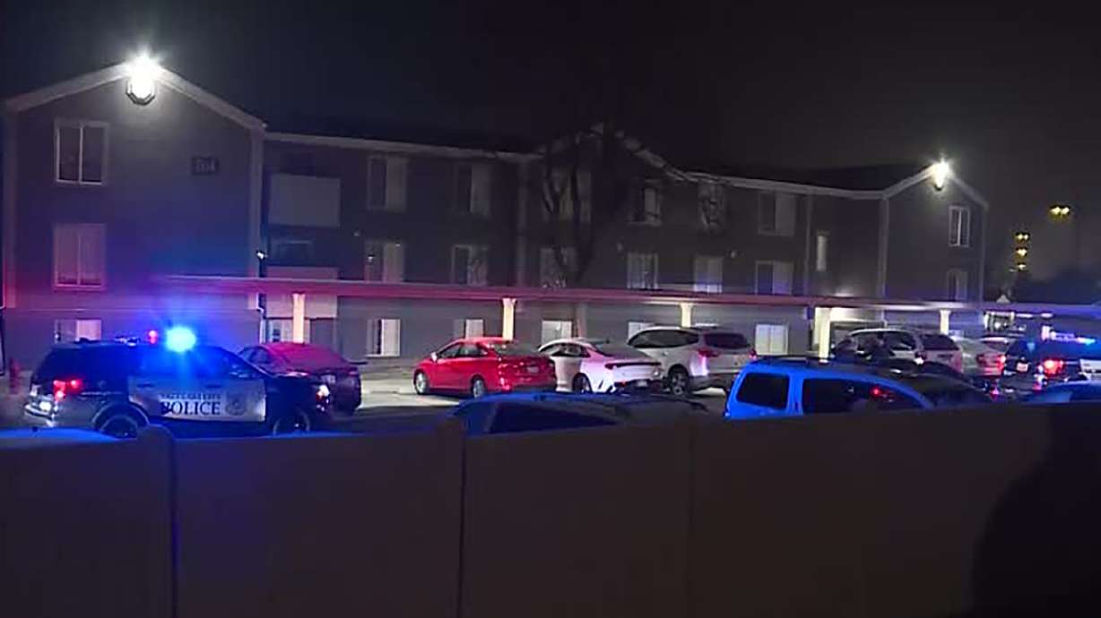 Salt Lake City police respond to a shooting at an apartment complex Wednesday. A carjacking at a McDonald's drive-thru early Wednesday in West Valley City and the shooting in Salt Lake City are believed to be connected, police say.