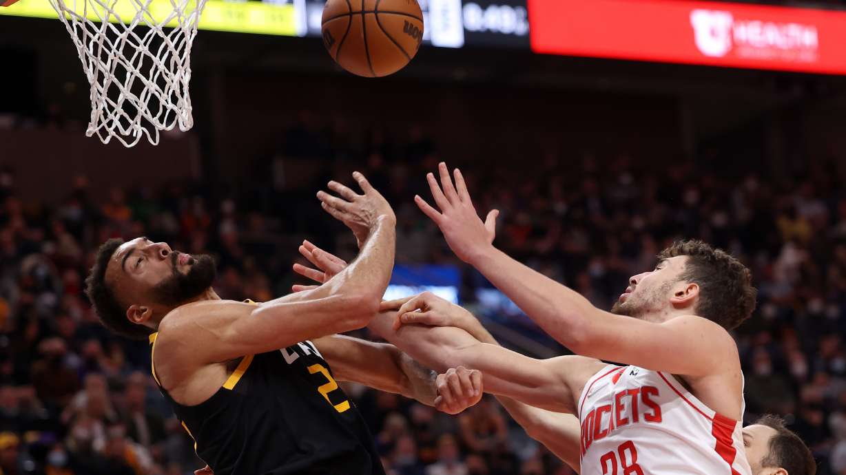 Utah Jazz center Rudy Gobert (27) battle with Houston Rockets center Alperen Sengun (28) for the Ball as Utah Jazz and the Houston Rockets play at Vivint Arena in Salt Lake City on Wednesday, Jan. 19, 2022. Houston won 116-111.