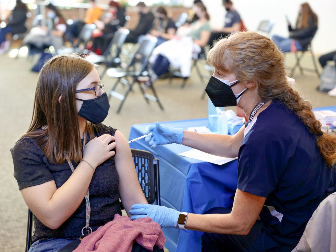 Tessa Schrom, a University of Utah senior, left, gets a
COVID-19 booster shot from Jana Ingles, a Community Nursing
Services registered nurse at the student union Thursday, during a vaccine clinic at the school.