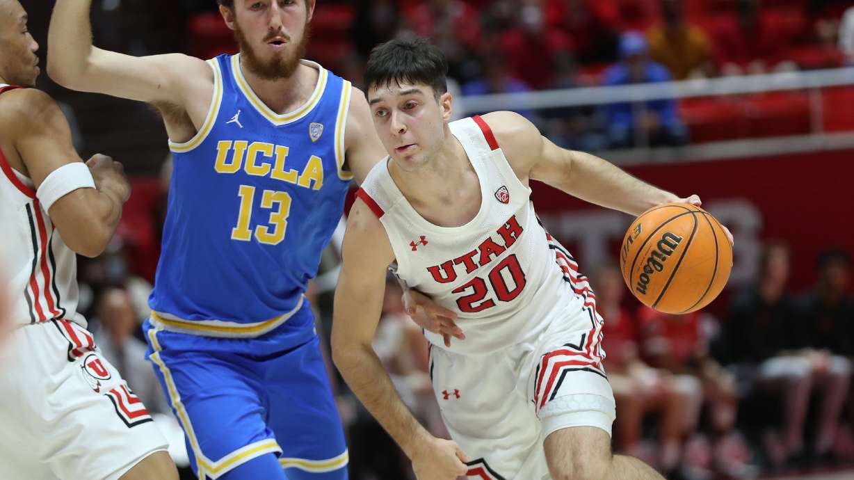 Utah Utes guard Lazar Stefanovic (20) drives ob UCLA Bruins guard Jake Kyman (13) in Salt Lake City on Thursday, Jan. 20, 2022.