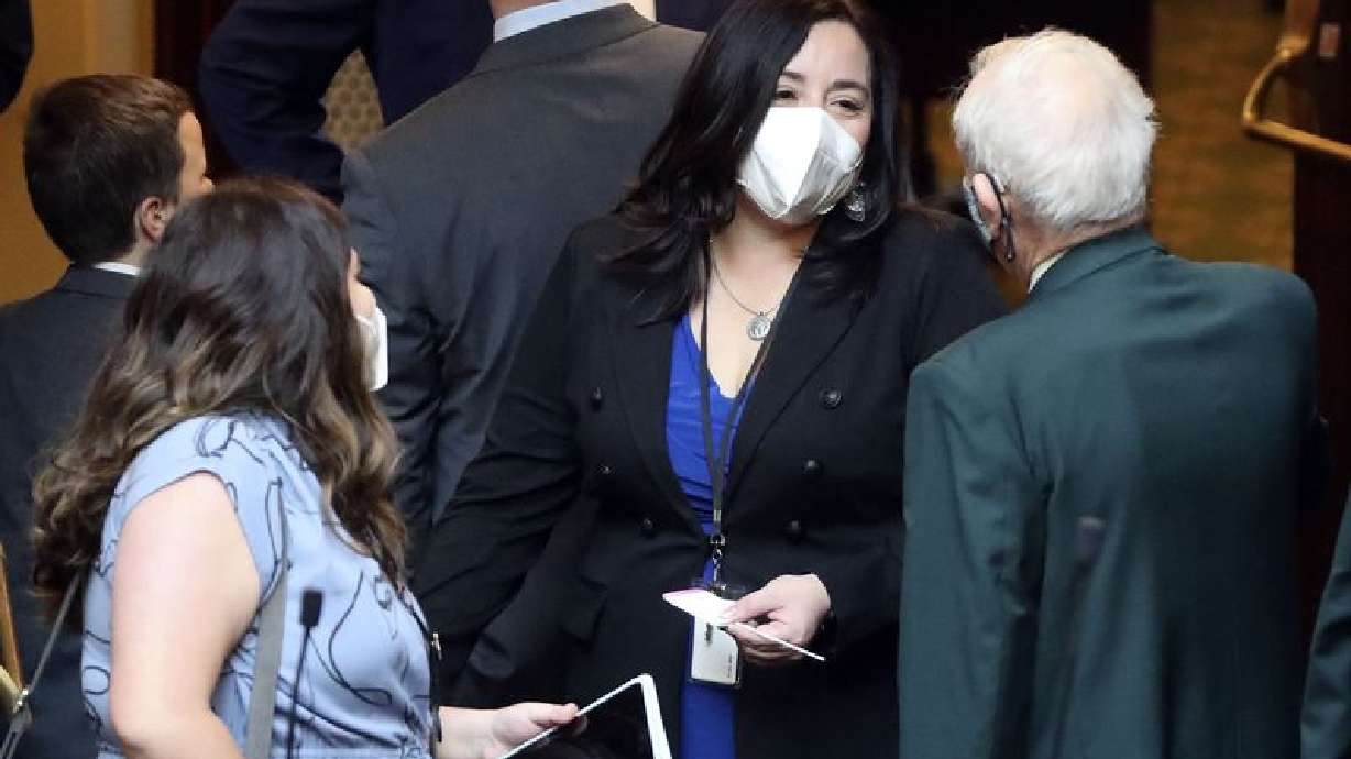 Rep. Angela Romero, D-Salt Lake City, carries her rapid COVID-19 test with her into the House chamber on the first day of
the legislative session at the Capitol in Salt Lake City on Tuesday. Romero on Friday announced she has tested positive for COVID-19.