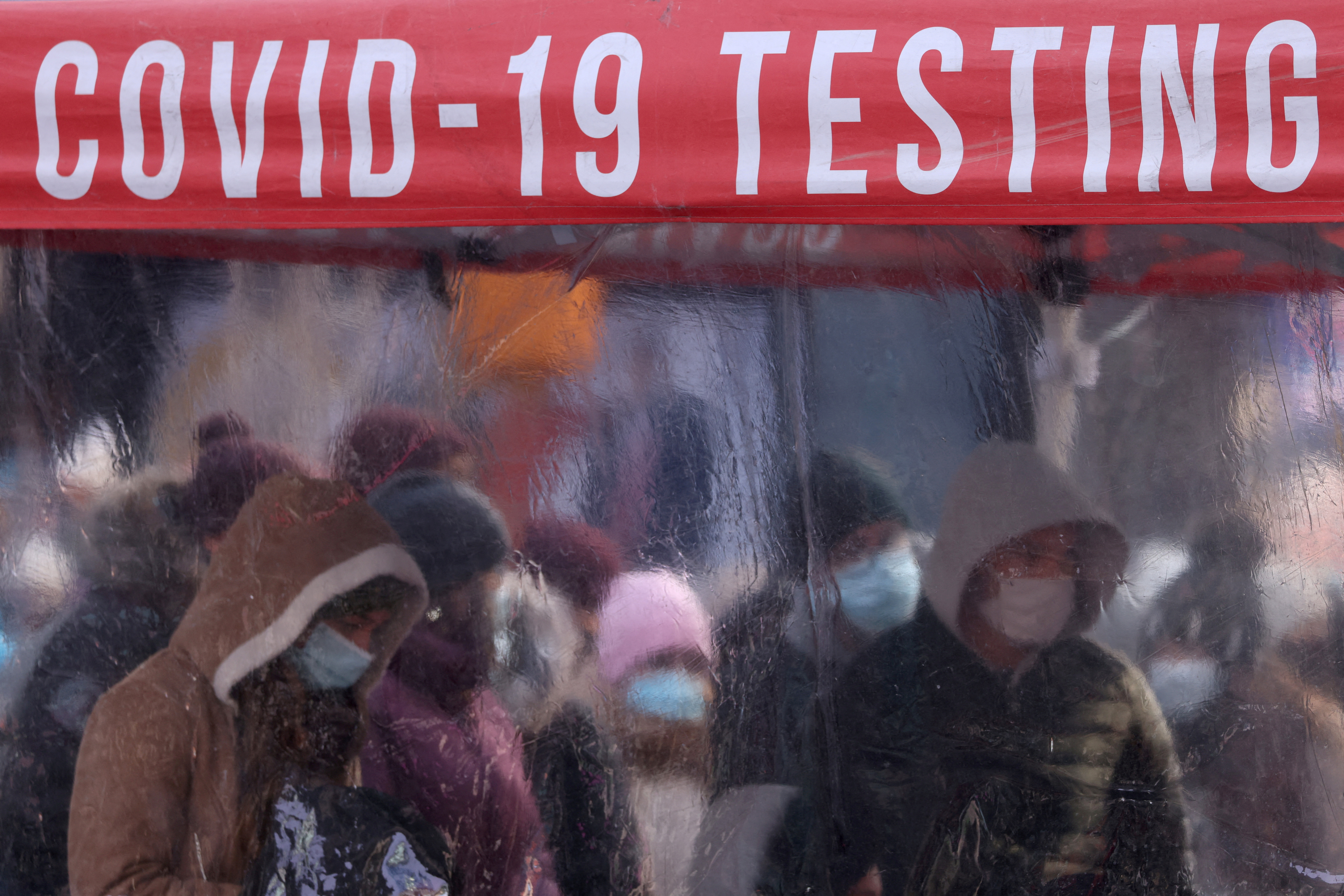 People queue to be tested for COVID-19 in Times Square in Manhattan, New York City, U.S., December 20, 2021.