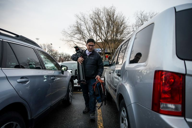 Mike Anderson, a reporter for KSL-TV, walks back to his
car after a live shoot in Logan on Friday.