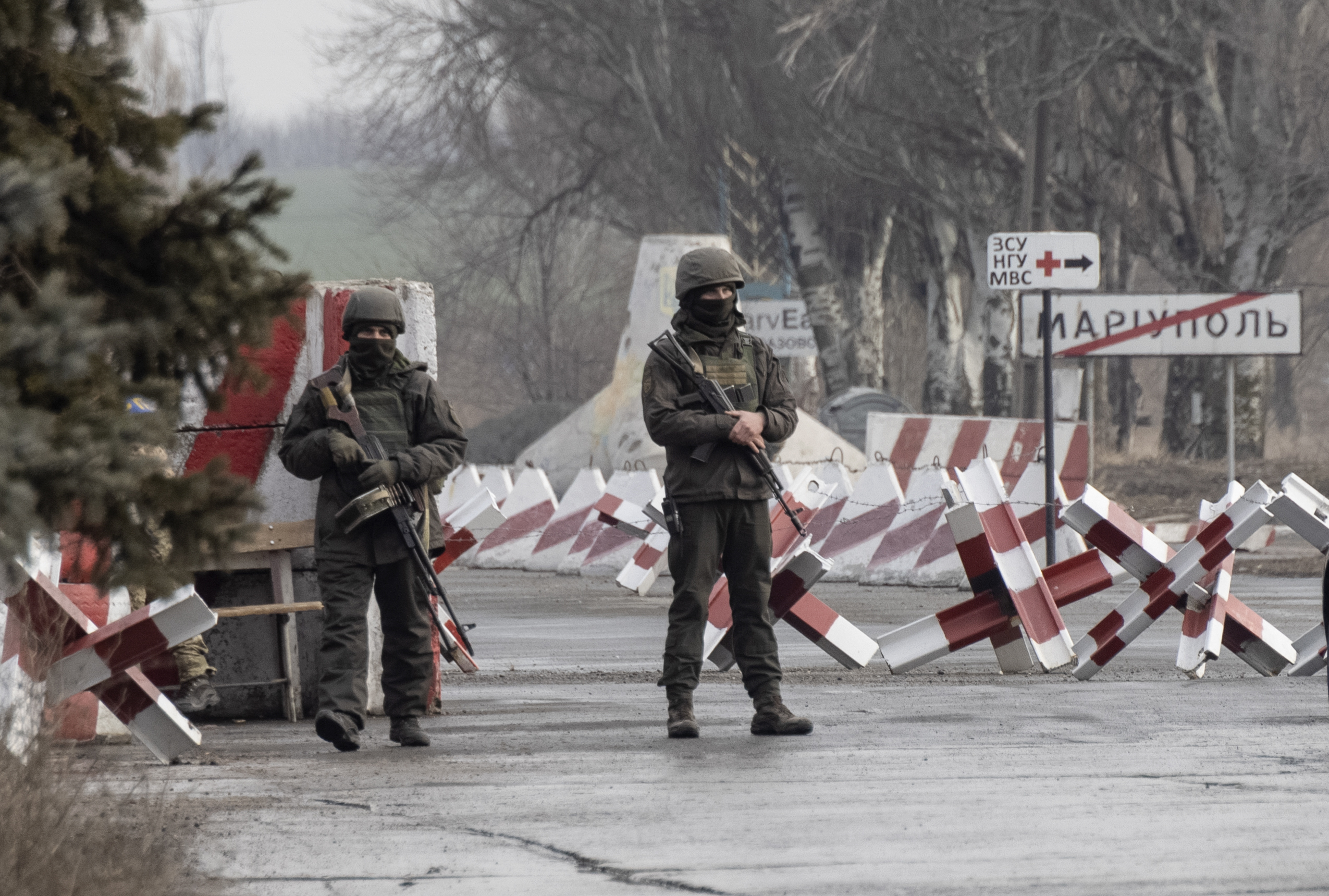 Ukrainian soldiers stand on a checkpoint close to the line of separation from pro-Russian rebels, Mariupol, Donetsk region, Ukraine, Friday. The United States and its allies have repeatedly promised consequences such as biting economic sanctions against Russia — though not military action — if it invades.