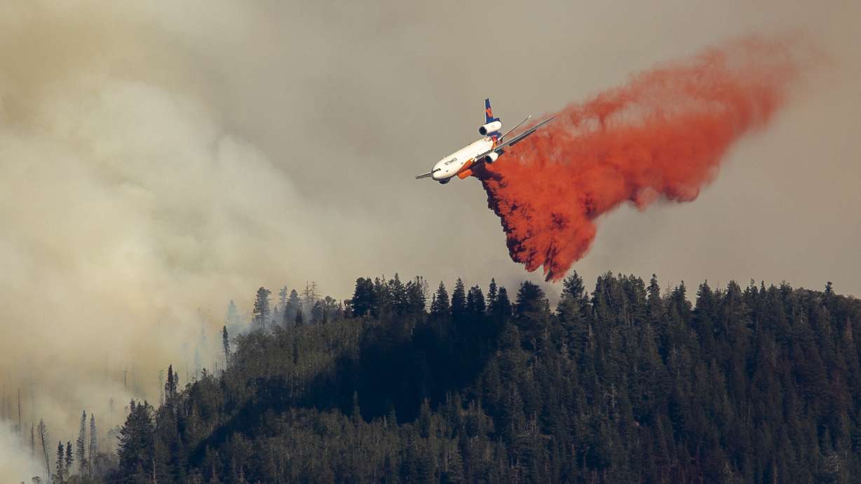 An air tanker drops retardant on the Parleys Canyon west of Park City on Saturday, Aug. 14, 2021.