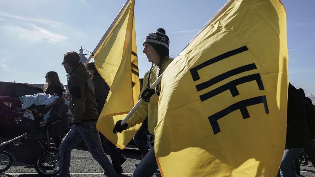 Gemma Wellwerts holds a flag during the March for Life rally outside of the Utah Capitol in Salt Lake City on Saturday.