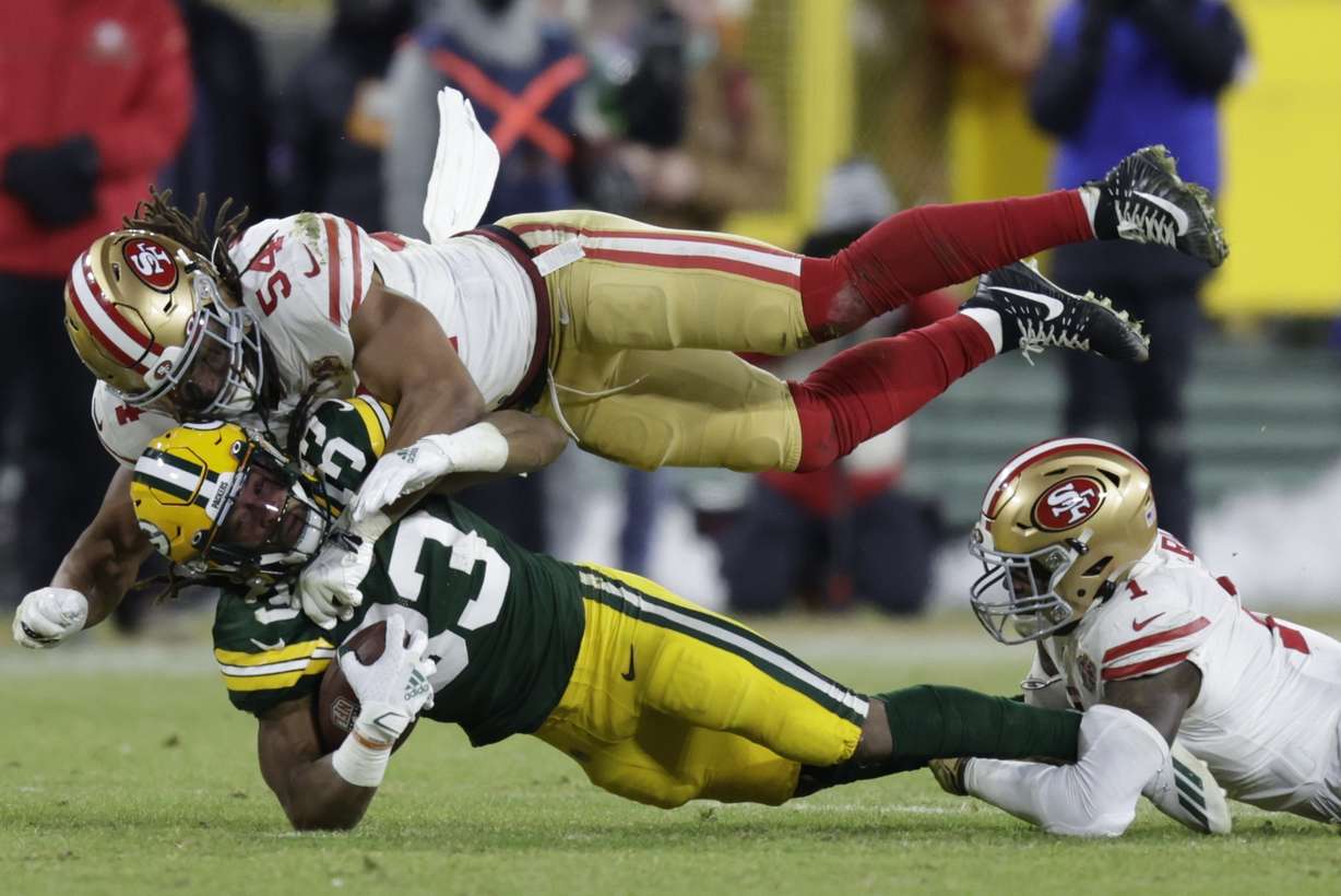 San Francisco 49ers' Fred Warner stops Green Bay Packers' Aaron Jones during the first half of an NFC divisional playoff NFL football game Saturday, Jan. 22, 2022, in Green Bay, Wis.