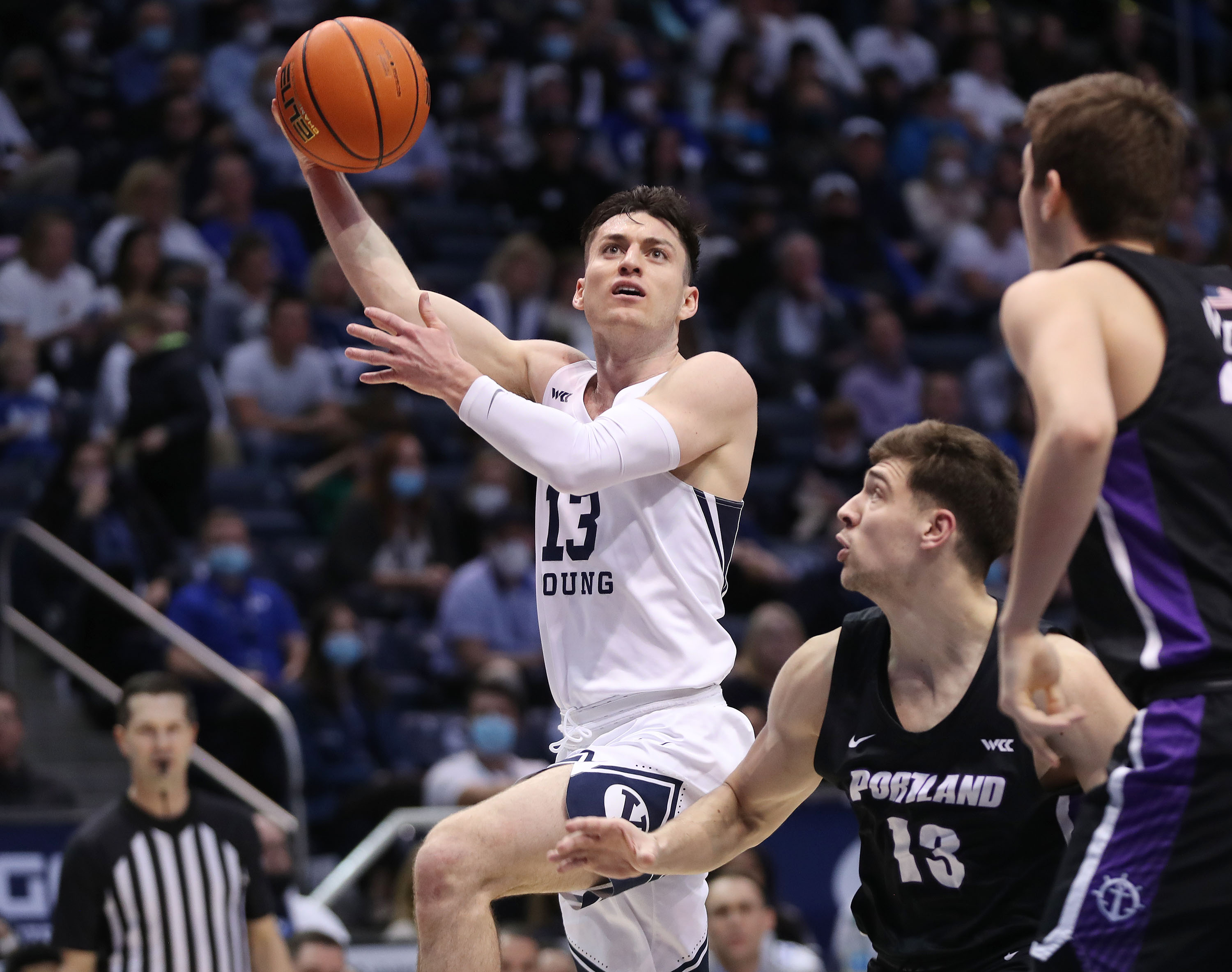 Brigham Young Cougars guard Alex Barcello (13) drives on Portland Pilots guard Matija Svetozarevic (13)  in Provo on Saturday, Jan. 22, 2022.