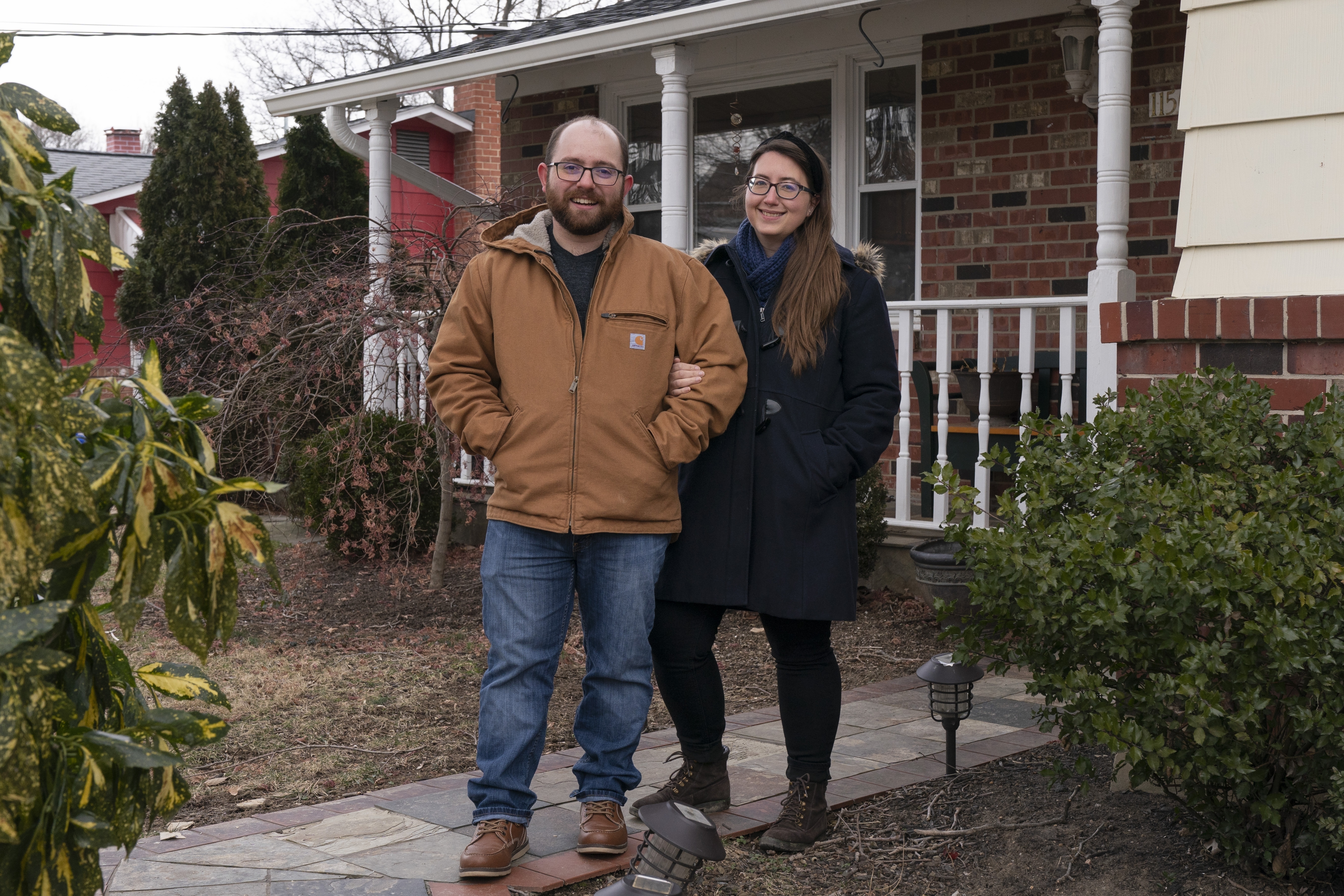 Ethan Miller and Rachel Mandelbaum pose for a portrait outside their home in Silver Spring, Md., Friday, Jan., 21, 2022. Tax filing season starts Monday and people can expect the task to be more cumbersome than usual this year thanks to an overloaded and understaffed IRS workforce and new complications from pandemic-related programs.