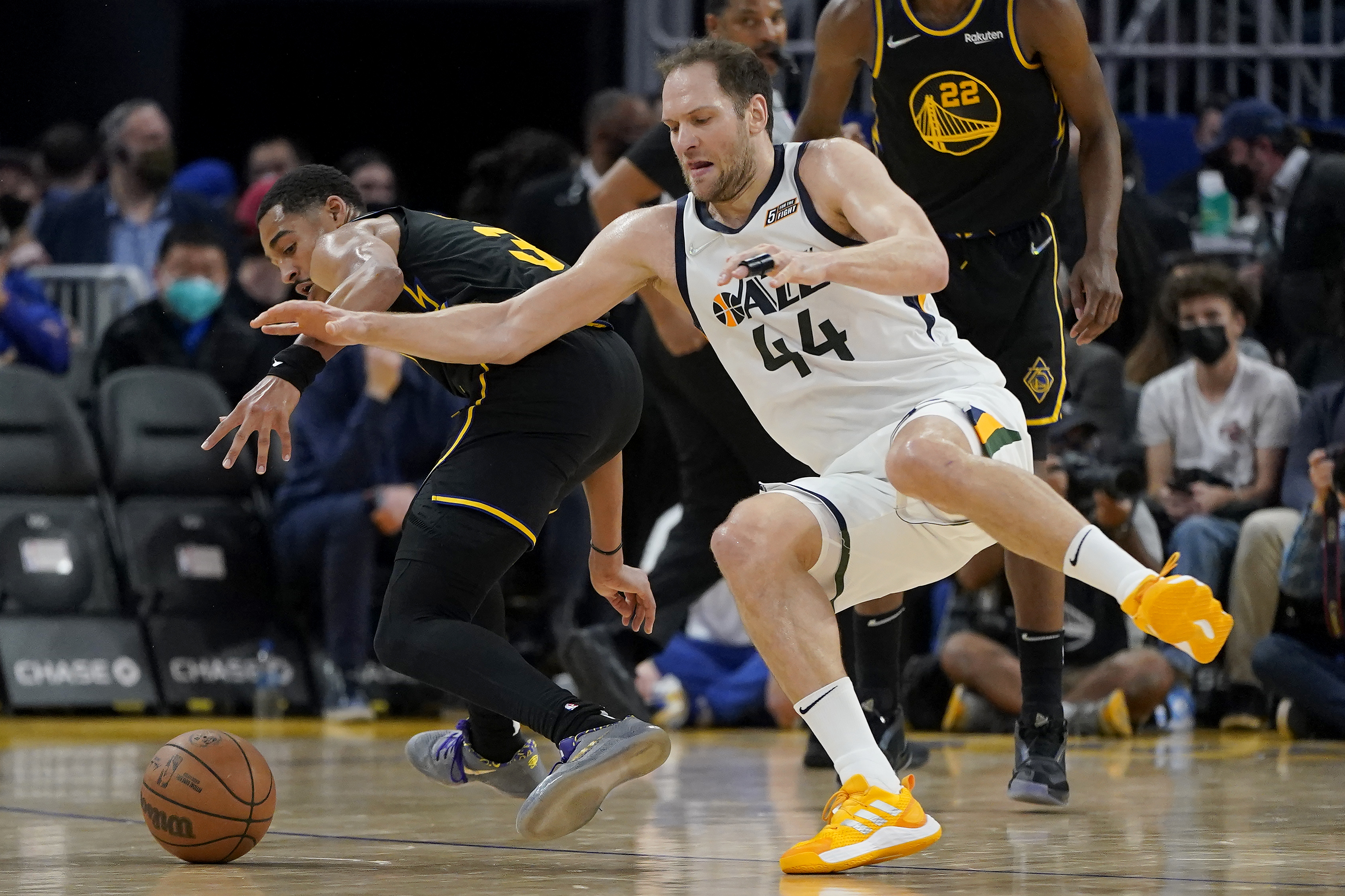 Utah Jazz forward Bojan Bogdanovic (44) loses the ball after being fouled by Golden State Warriors guard Jordan Poole, left, during the first half of an NBA basketball game in San Francisco, Sunday, Jan. 23, 2022. 