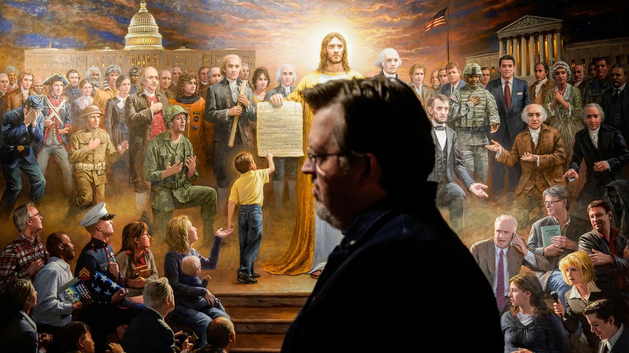 Artist Jon McNaughton stands in front of one of his paintings at his studio in Utah County on Monday, Nov. 22, 2021.