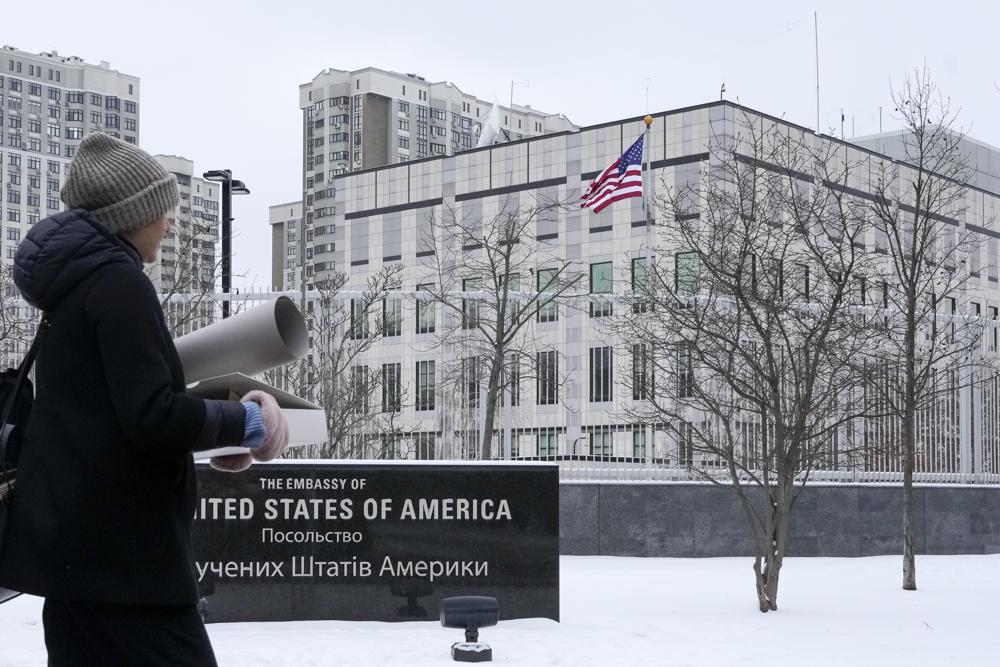 A woman walks past the U.S. Embassy in Kyiv, Ukraine, Monday. The State Department is ordering the families of all American personnel at the U.S. Embassy in Kyiv to leave the country and allowing non-essential staff to leave Ukraine.