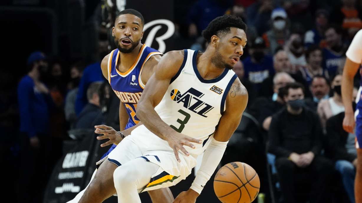 Utah Jazz guard Trent Forrest (3) spins around Phoenix Suns forward Mikal Bridges (25) during the first half of an NBA basketball game, Monday, Jan. 24, 2022, in Phoenix.