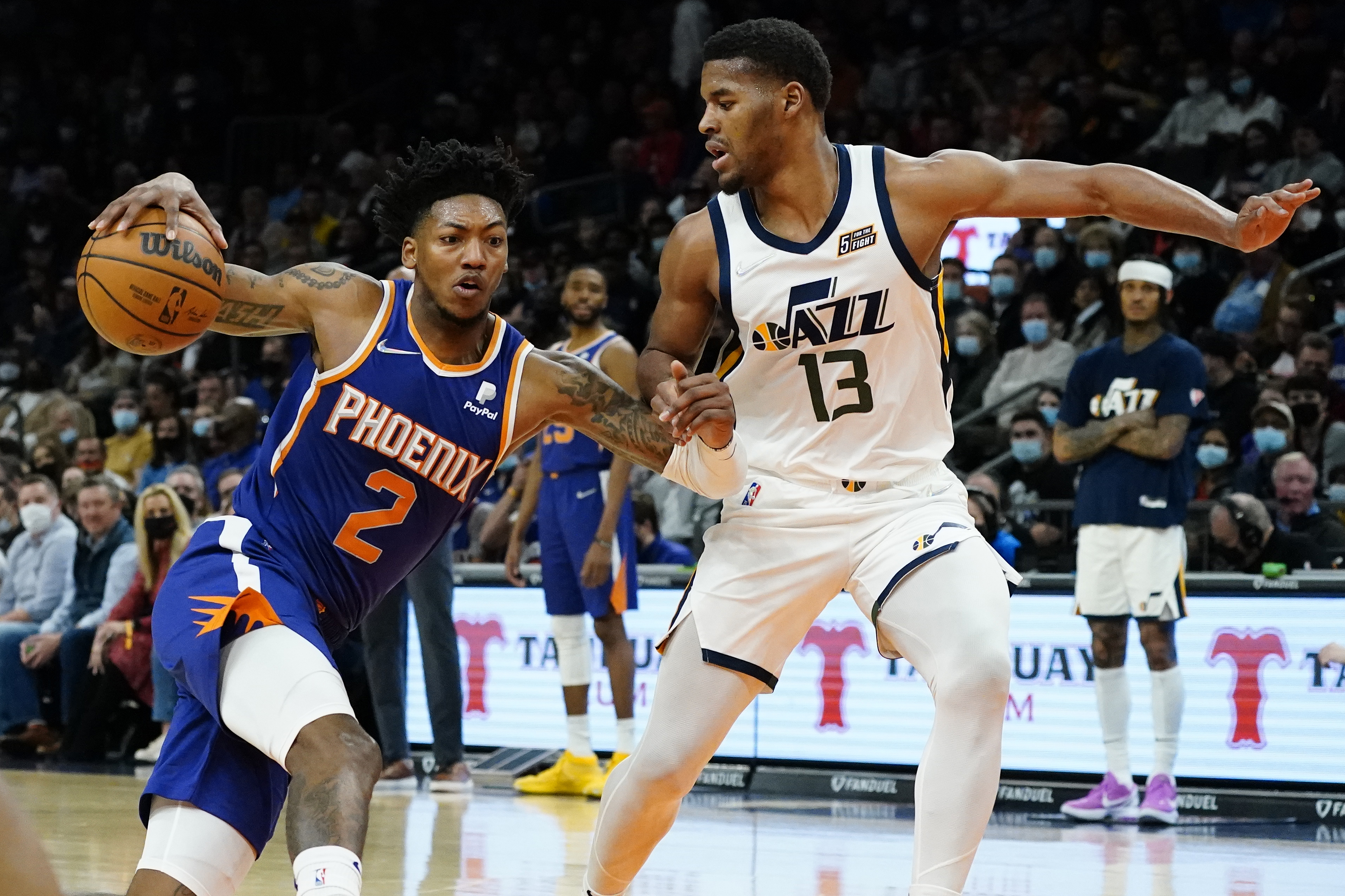 Phoenix Suns guard Elfrid Payton (2) drives as Utah Jazz guard Jared Butler (13) defends during the first half of an NBA basketball game, Monday, Jan. 24, 2022, in Phoenix. 