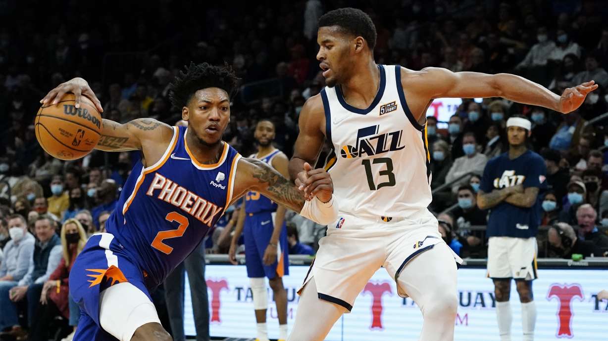 Phoenix Suns guard Elfrid Payton (2) drives as Utah Jazz guard Jared Butler (13) defends during the first half of an NBA basketball game, Monday, Jan. 24, 2022, in Phoenix.