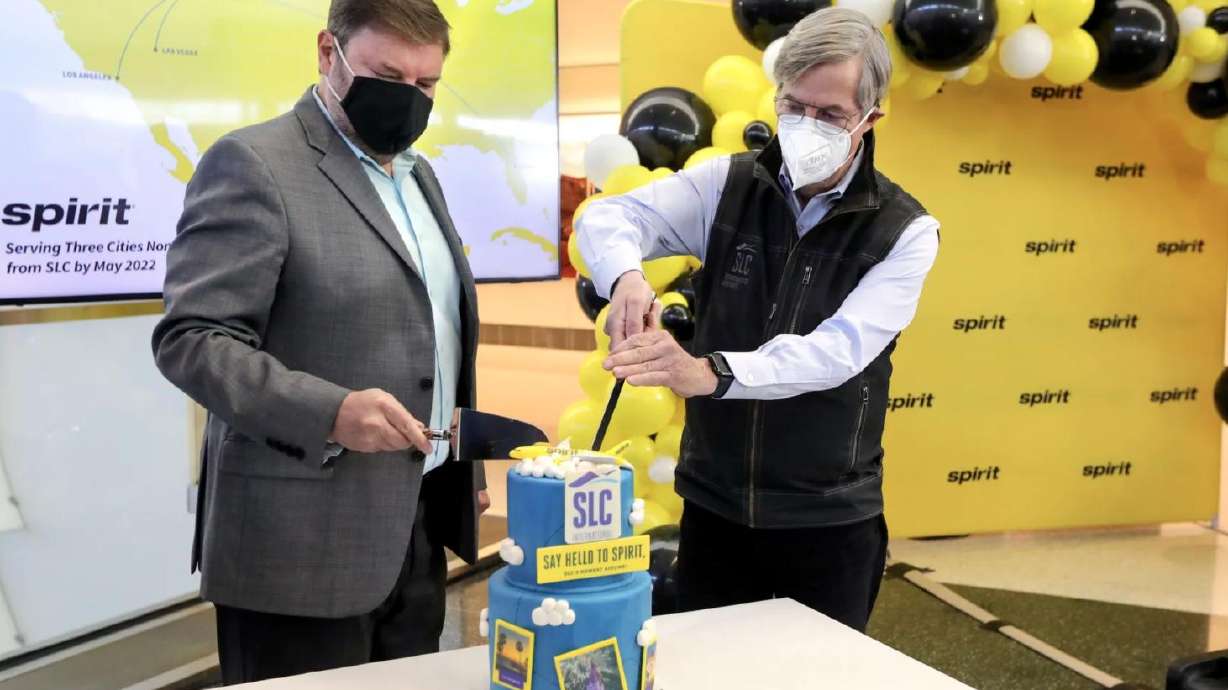 John Kirby, Spirit Airlines network planning vice president, and Salt Lake City Department of Airports executive director Bill Wyatt cut a celebratory cake after announcing that Spirit Airlines will begin service to and from Salt Lake City in May, during a press conference at Salt Lake City International Airport in Salt Lake City on Tuesday, Jan. 25, 2022.