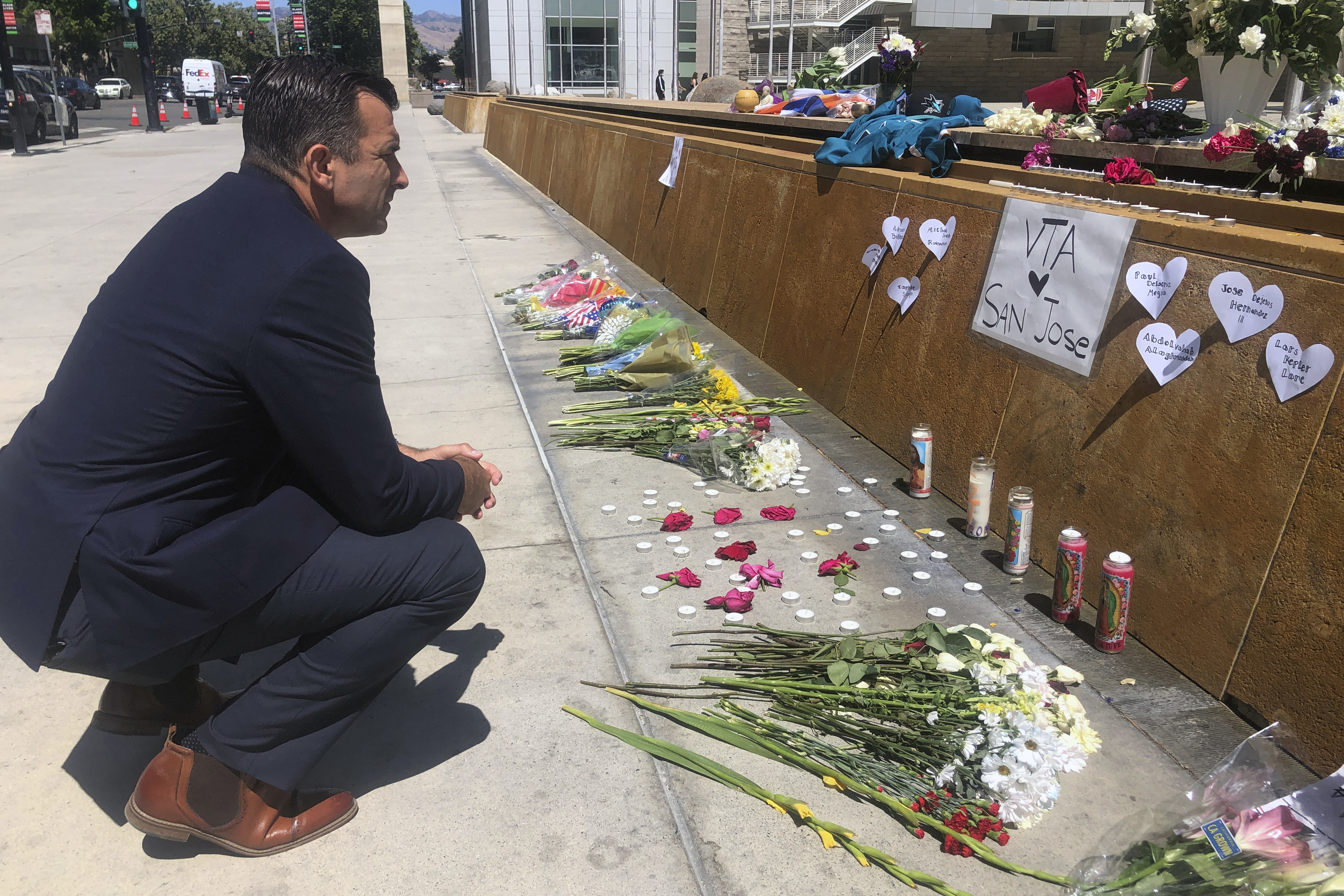 San Jose Mayor Sam Liccardo stops to view a makeshift memorial for the rail yard shooting victims in front of City Hall in San Jose, Calif., on May 27, 2021. Gun owners would be required to carry liability insurance and pay a fee under a proposed ordinance in the city of San Jose that officials say would be the first of its kind in the U.S. 