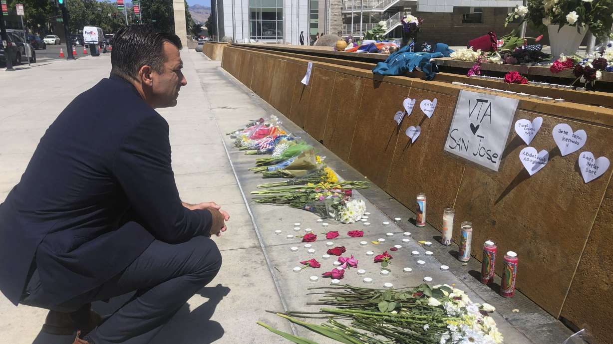 San Jose Mayor Sam Liccardo stops to view a makeshift memorial for the rail yard shooting victims in front of City Hall in San Jose, Calif., on May 27, 2021. Gun owners would be required to carry liability insurance and pay a fee under a proposed ordinance in the city of San Jose that officials say would be the first of its kind in the U.S.