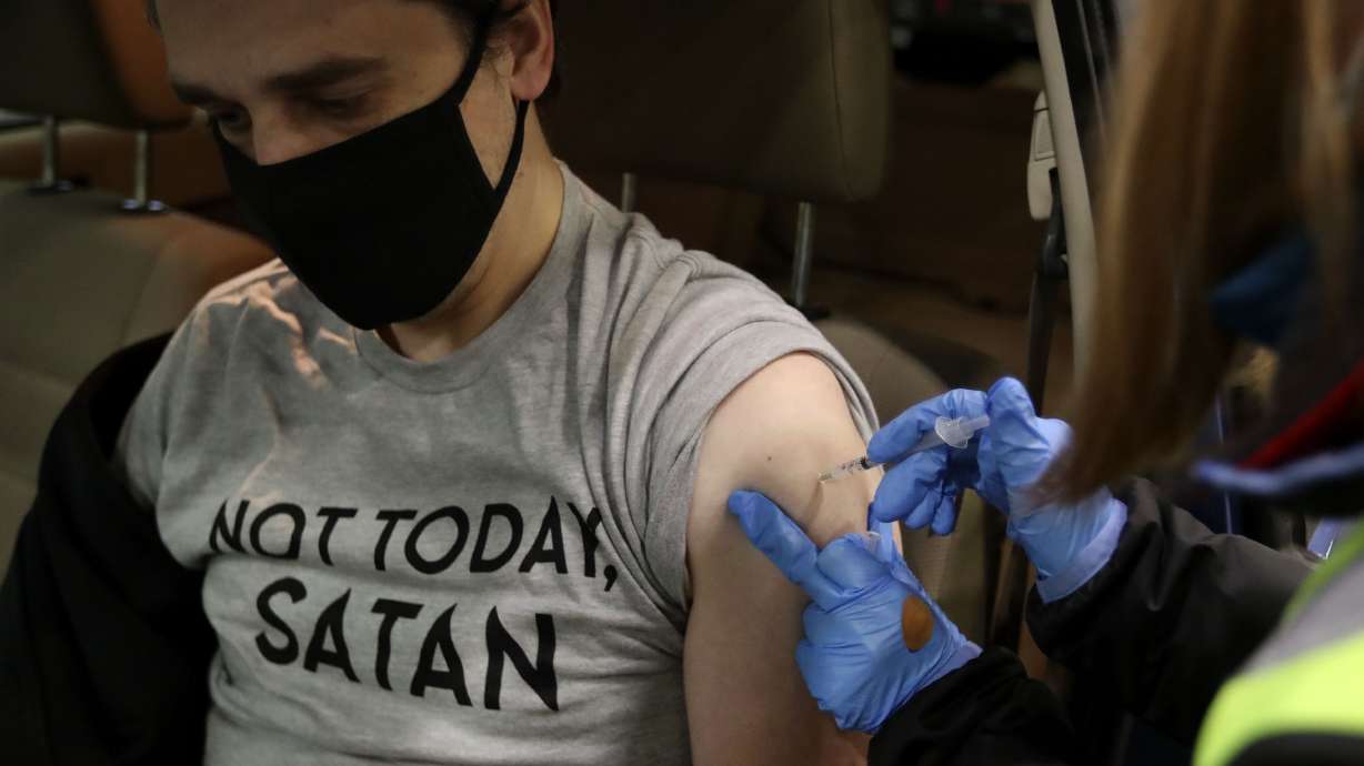Nick Champlin of Layton receives a COVID-19 vaccination at the Legacy Events Center in Farmington on Jan. 19. An additional 18 COVID-19 deaths were reported in Utah on Tuesday, along with 7,493 new cases.