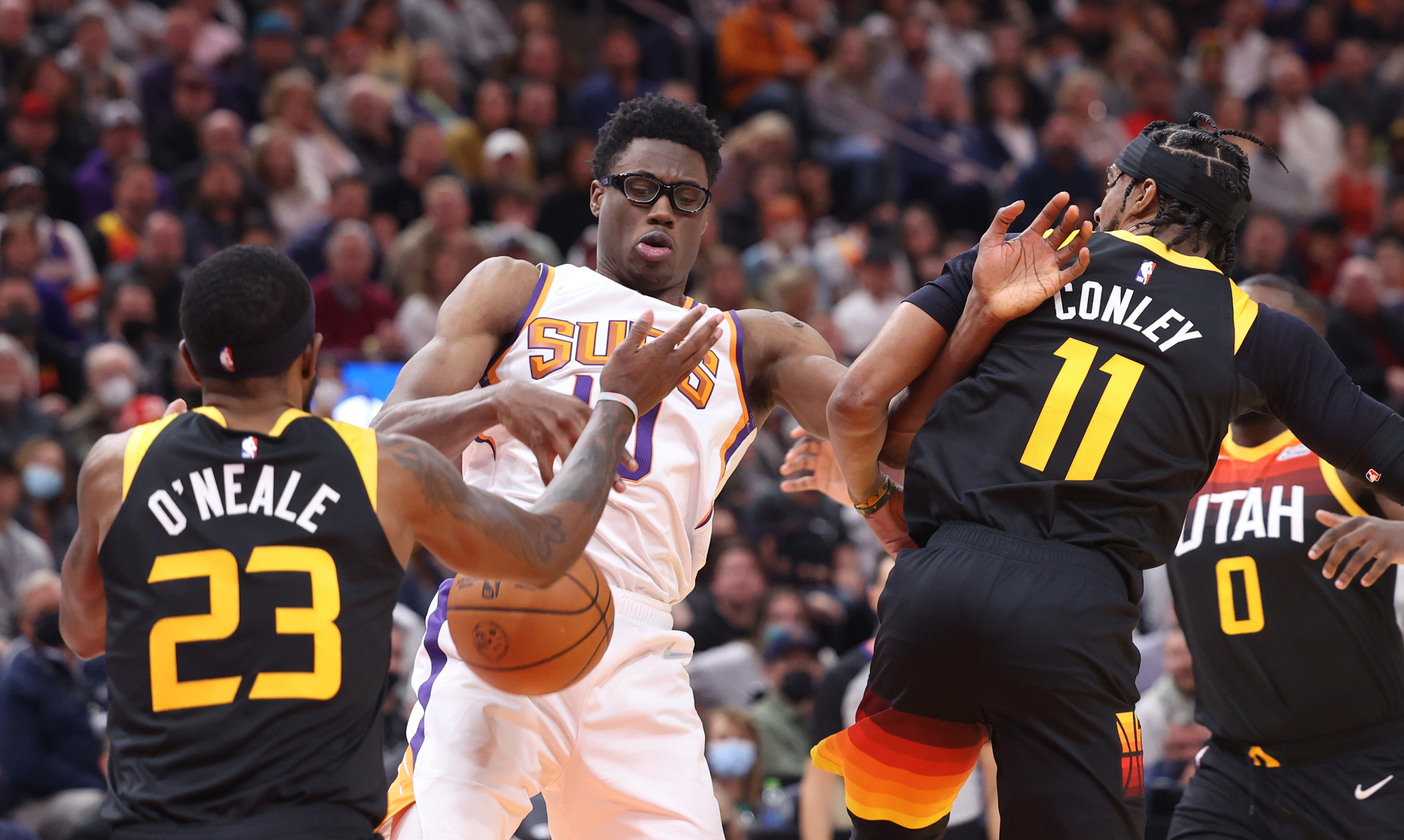 Utah Jazz forward Royce O'Neale (23) and Utah Jazz guard Mike Conley (11) gang up on Phoenix Suns forward Jalen Smith (10) as the Utah Jazz and the Phoenix Suns play an NBA basketball game in Salt Lake City at Vivint Arena on Wednesday, Jan. 26, 2022.