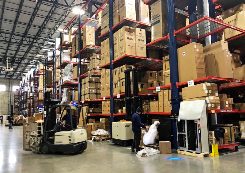 Warehouse workers deal with inventory stacked up to the ceiling at an ABT Electronics Facility in Glenview, Illinois, Dec. 4, 2018. The U.S. economy notched its strongest growth in nearly four decades in 202, the government reported Thursday.