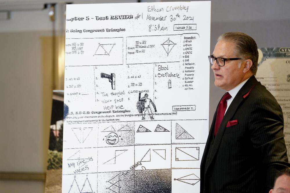 Attorney Ven Johnson shows a blowup of Ethan Crumbley's test review paper with notes and drawings during a news conference in Southfield, Mich., Thursday.