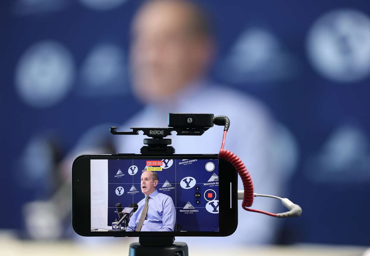 A cellphone records as Brigham Young University athletic director Tom Holmoe speaks during a press conference in Provo on Thursday, Jan. 27, 2022.