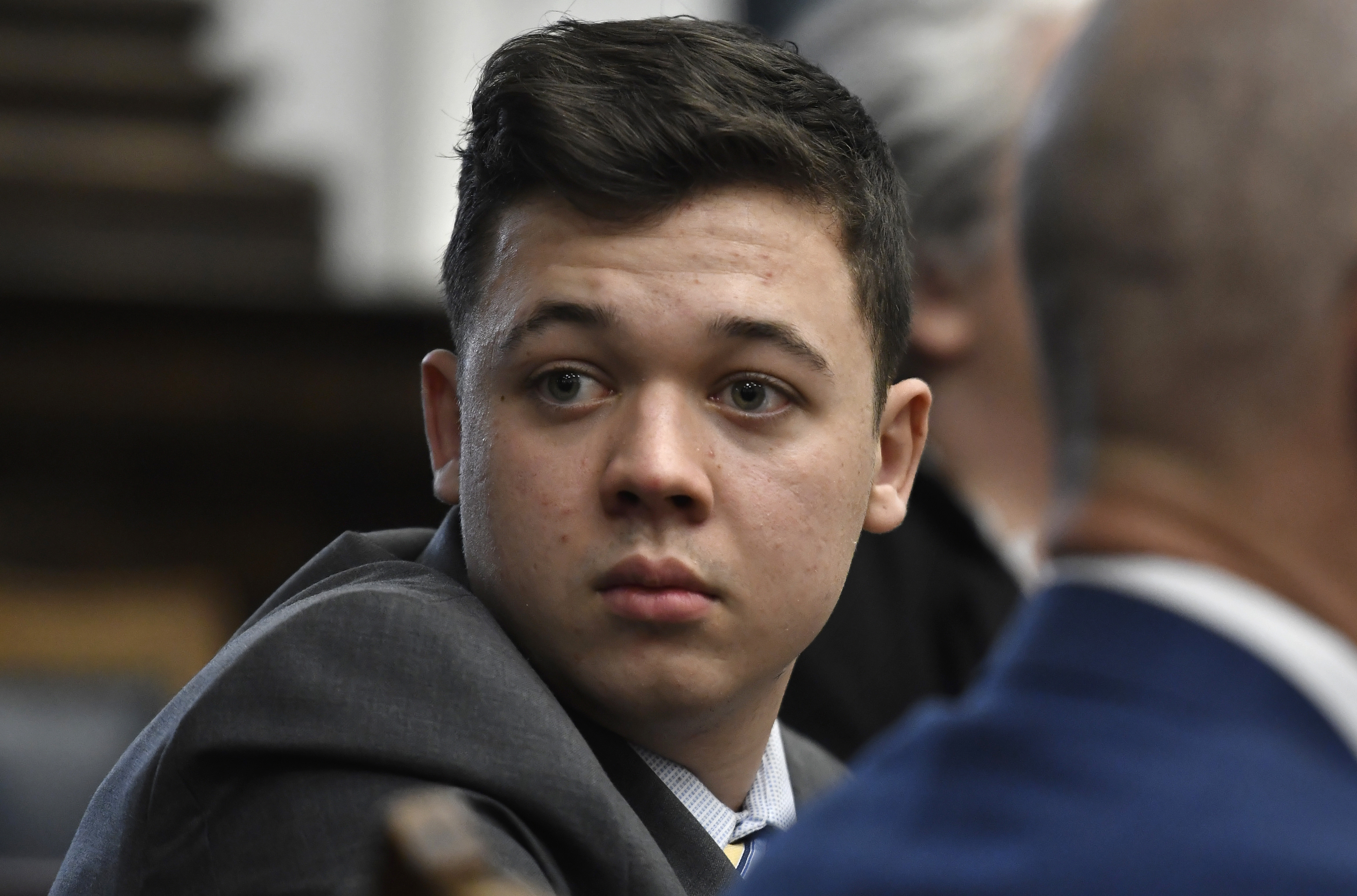 Kyle Rittenhouse looks back as attorneys discuss items in the motion for mistrial at the Kenosha County Courthouse in Kenosha, Wisconsin, on Nov. 17, 2021.