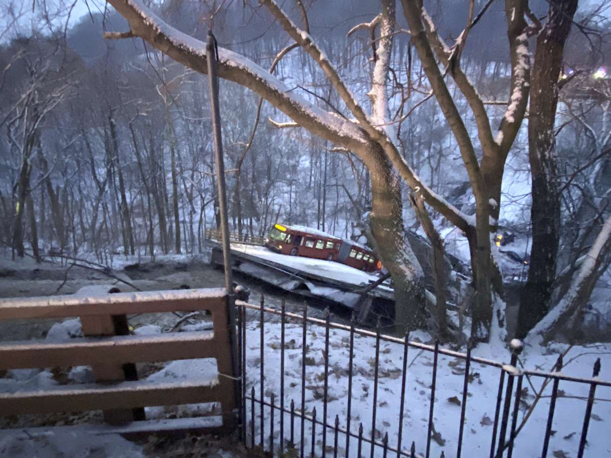 A commuter bus sits upright on a section of a collapsed bridge in Pittsburgh, on Friday.