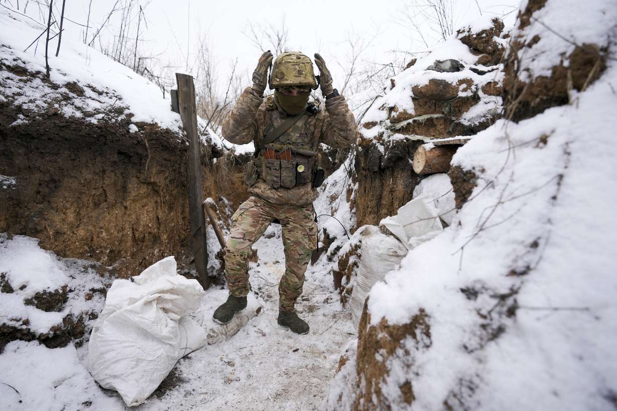 A Ukrainian serviceman walks to his position in a trench on the front line in the Luhansk region, eastern Ukraine, Friday. High-stakes diplomacy continued on Friday in a bid to avert a war in Eastern Europe.