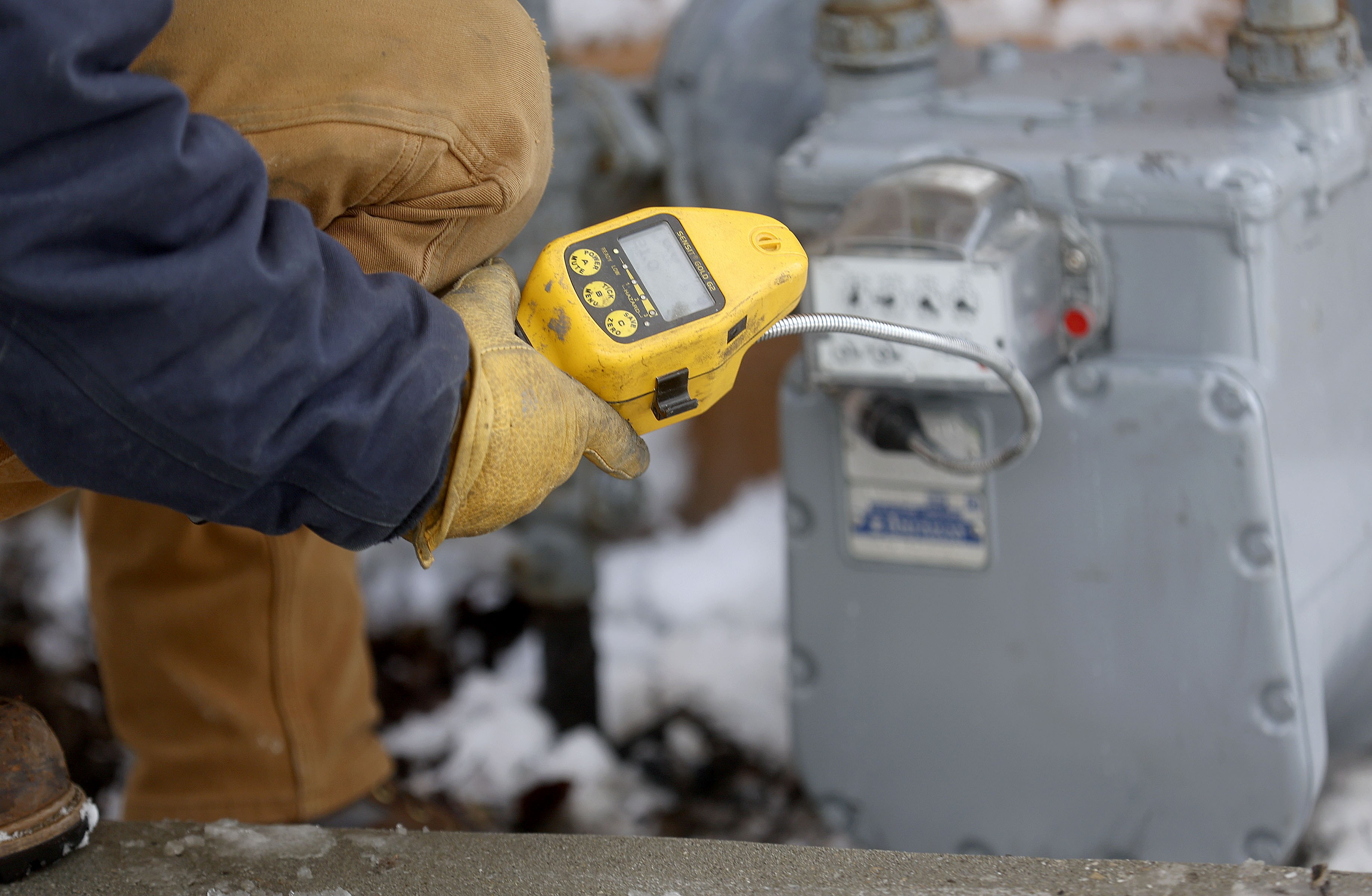Kylie Hrubes, a Dominion Energy utility worker, checks for gas leaks after replacing a gas meter in West Valley City on Feb. 17, 2021. A new Dominion Energy program will allow Utah and Idaho customers to purchase carbon offsets that account for the greenhouse gases their natural gas usage emits into the atmosphere.