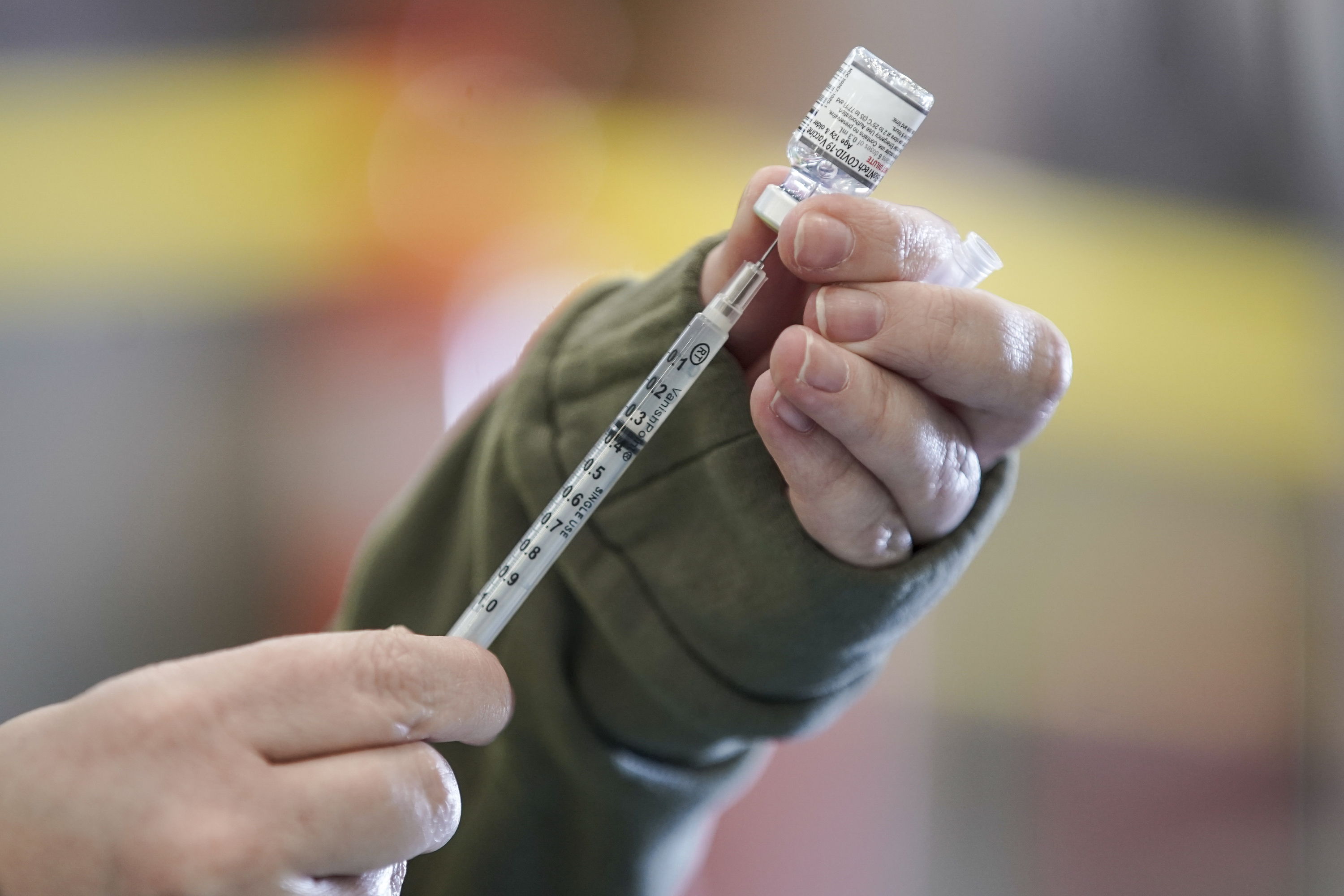 Registered nurse Erin Olpin draws a COVID-19 vaccination dose at a drive-thru clinic at the Legacy Events Center in Farmington on Monday. Utah health officials reported 10 additional COVID-19 deaths on Friday, along with 6,166 new cases.