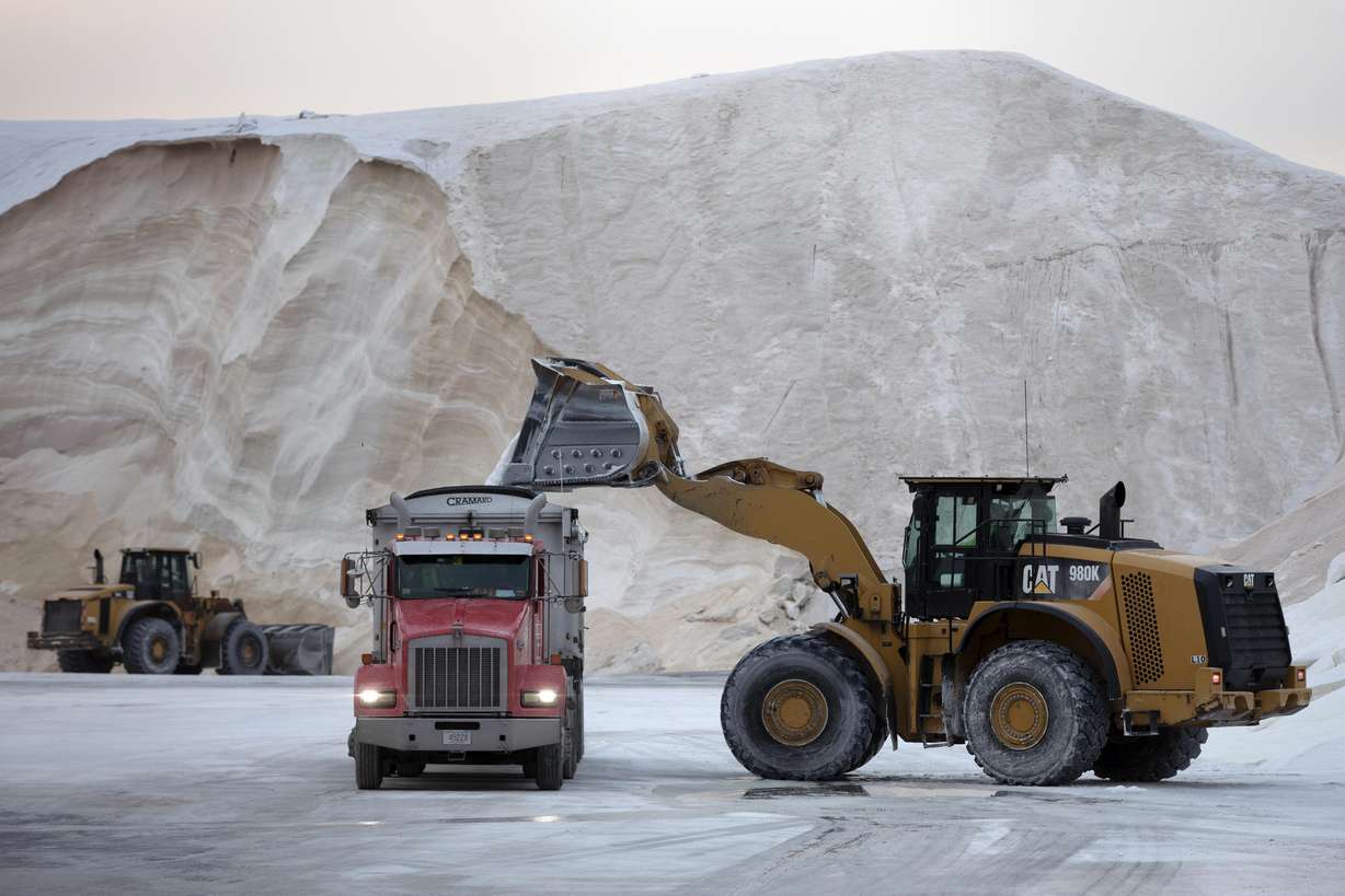 A front-end loader dumps road salt into a truck Friday in Chelsea, Mass. Residents and officials in the Northeast and mid-Atlantic regions of the U.S. are bracing for a powerful winter storm expected to produce blizzard conditions Friday and Saturday.