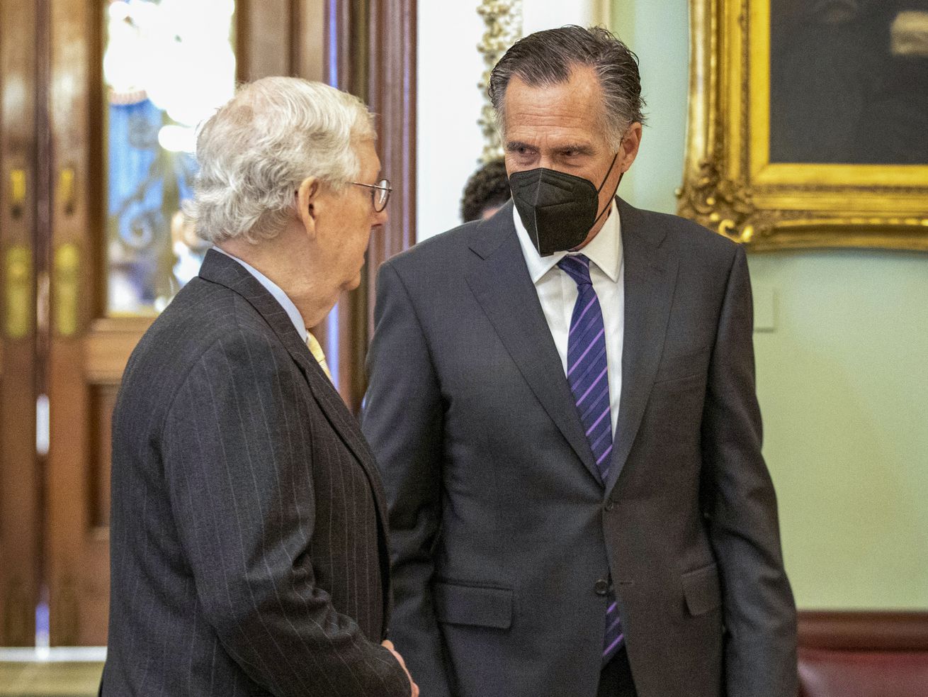 Senate Minority Leader Mitch McConnell, R-Ky., left,
speaks to Sen. Mitt Romney, R-Utah, at the Capitol in Washington,
Thursday, Jan. 13.