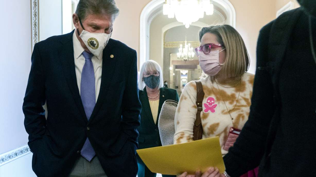 Sen. Joe Manchin, D-W.Va., left, walks with Sen. Kyrsten Sinema, D-Ariz., with Sen. Patty Murray, D-Wash., behind them at center, after attending a luncheon, on Nov. 16, 2021, on Capitol Hill. Democrats in Congress have fractured repeatedly over President Joe Biden's agenda, but not on Biden's nominations to the courts.