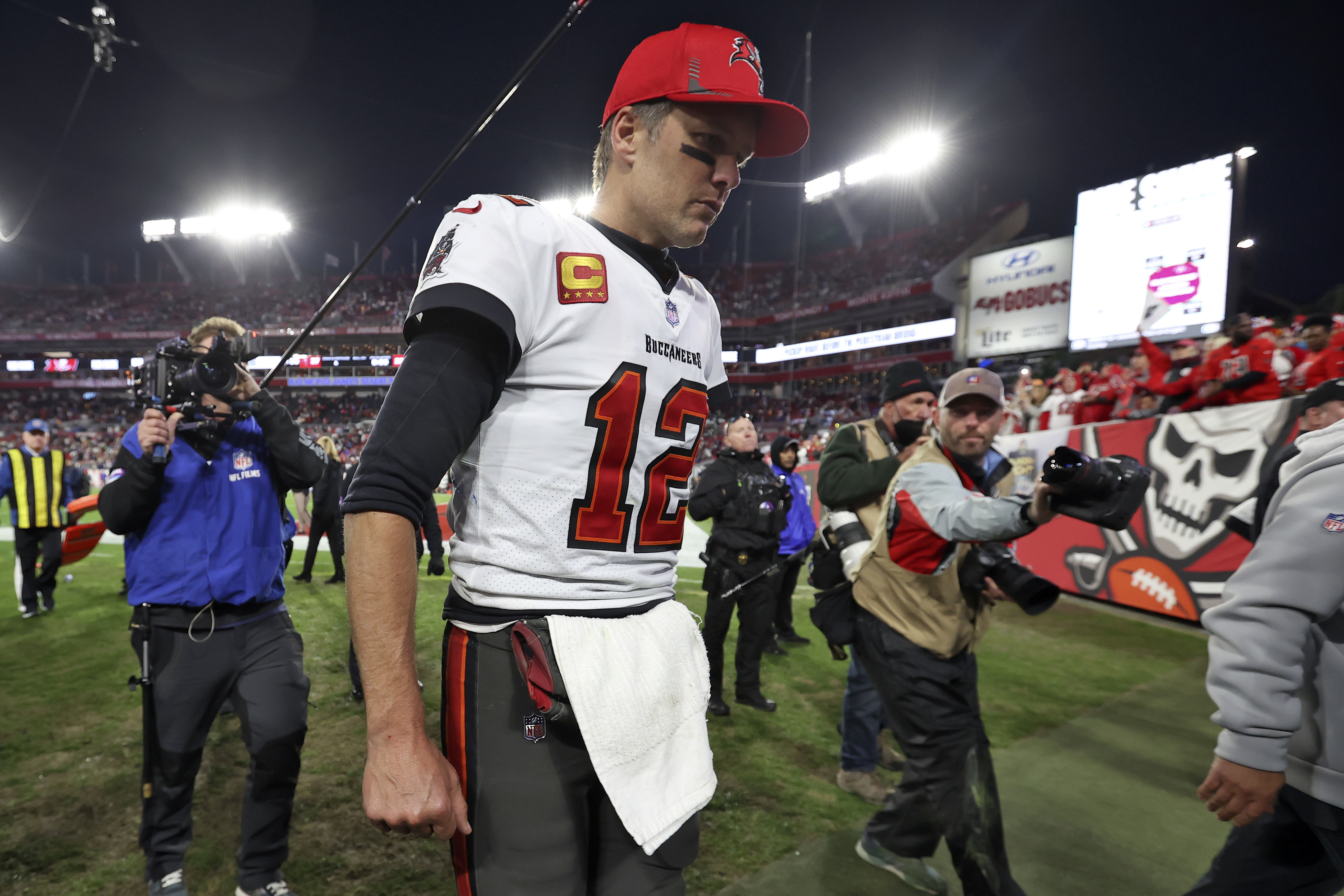 Tampa Bay Buccaneers quarterback Tom Brady (12) reacts as he leaves the field after the team lost to the Los Angeles Rams during an NFL divisional round playoff football game Sunday, Jan. 23, in Tampa, Fla.
