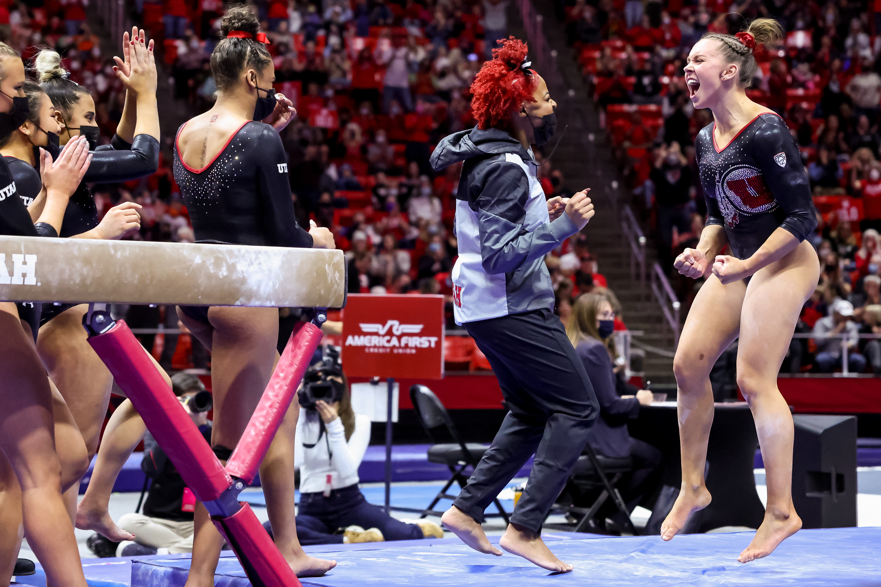 Utah’s Maile O’Keefe, right, celebrates with teammates after scoring a perfect 10 on beam during a meet against Stanford at the Huntsman Center in Salt Lake City on Saturday, Jan. 29, 2022.