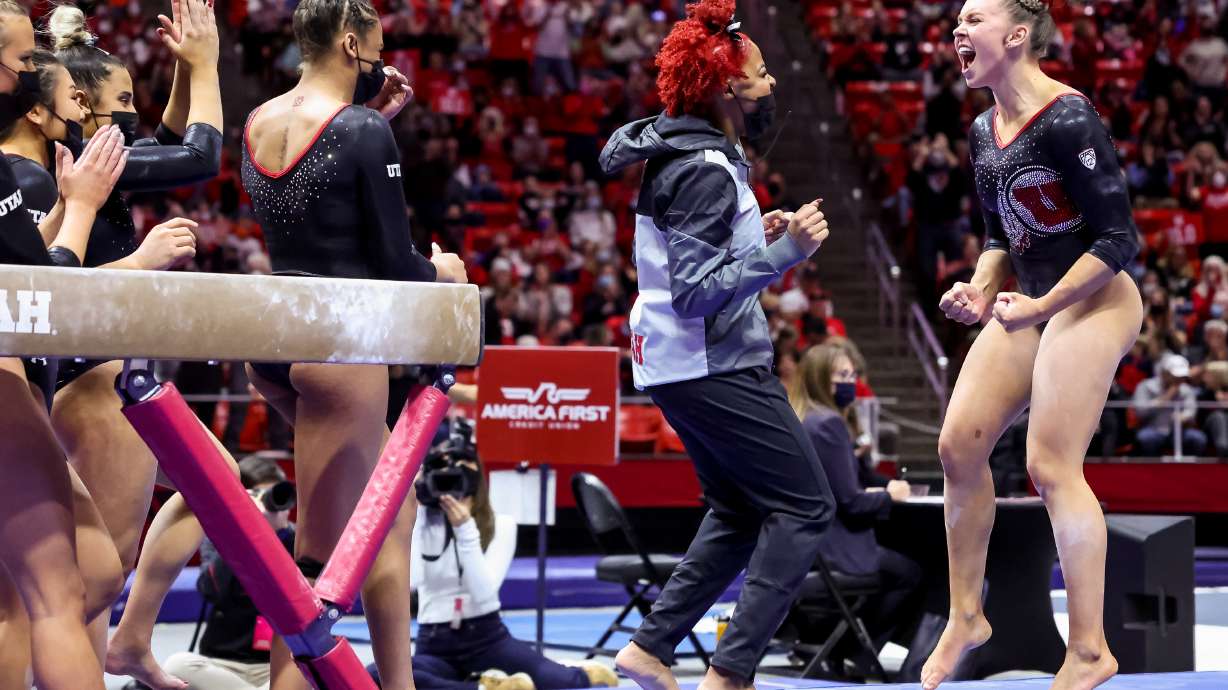 Utah’s Maile O’Keefe, right, celebrates with teammates after scoring a perfect 10 on beam during a meet against Stanford at the Huntsman Center in Salt Lake City on Saturday, Jan. 29, 2022.