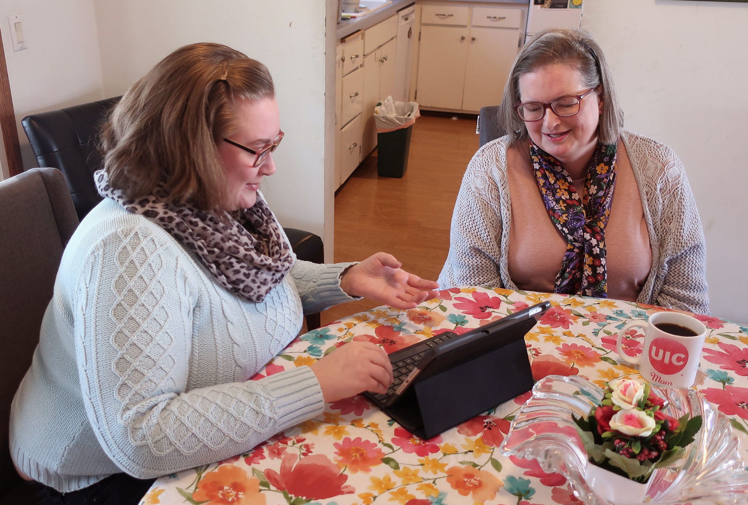 Helen Rottier, 25, shows her mother, Amy Rottier, 50, how she organizes her calendar on her iPad in Madison, Wis., on Wednesday. The two women illustrate the way Gen Xers and millennials differ in how they spent their time on an average day as young adults because of changes in technology and patterns in forming families over the last two decades. .
