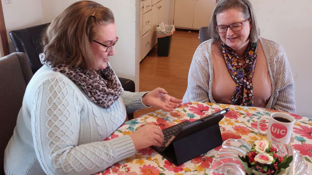 Helen Rottier, 25, shows her mother, Amy Rottier, 50, how she organizes her calendar on her iPad in Madison, Wis., on Wednesday. The two women illustrate the way Gen Xers and millennials differ in how they spent their time on an average day as young adults because of changes in technology and patterns in forming families over the last two decades. .