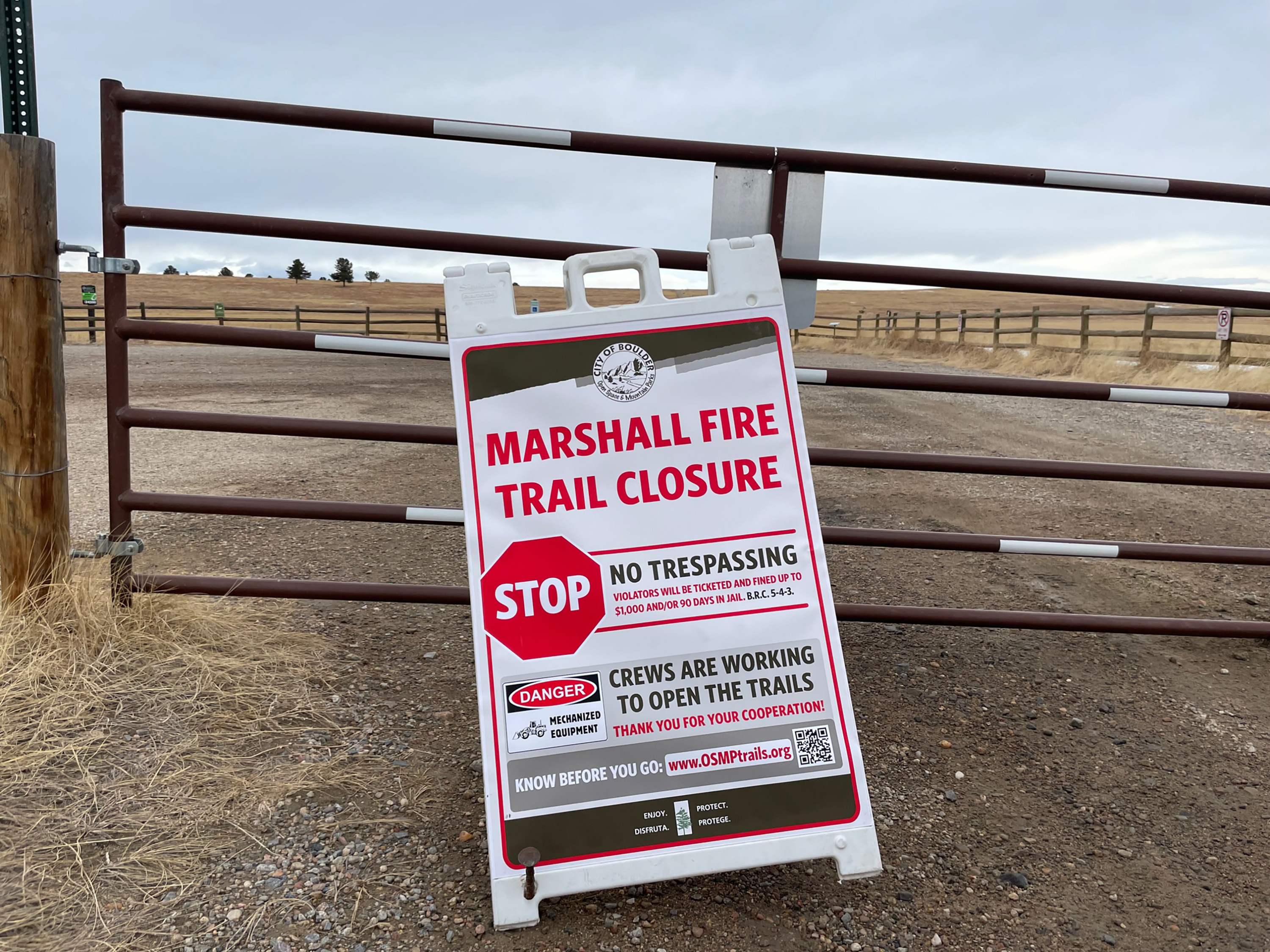 A sign advises visitors that trails in the vicinity of Marshall Mesa administered by City of Boulder Open Space and Mountain Parks, including this trailhead at Greenbelt Plateau, remain closed because of the Marshall fire near Boulder, Colo.